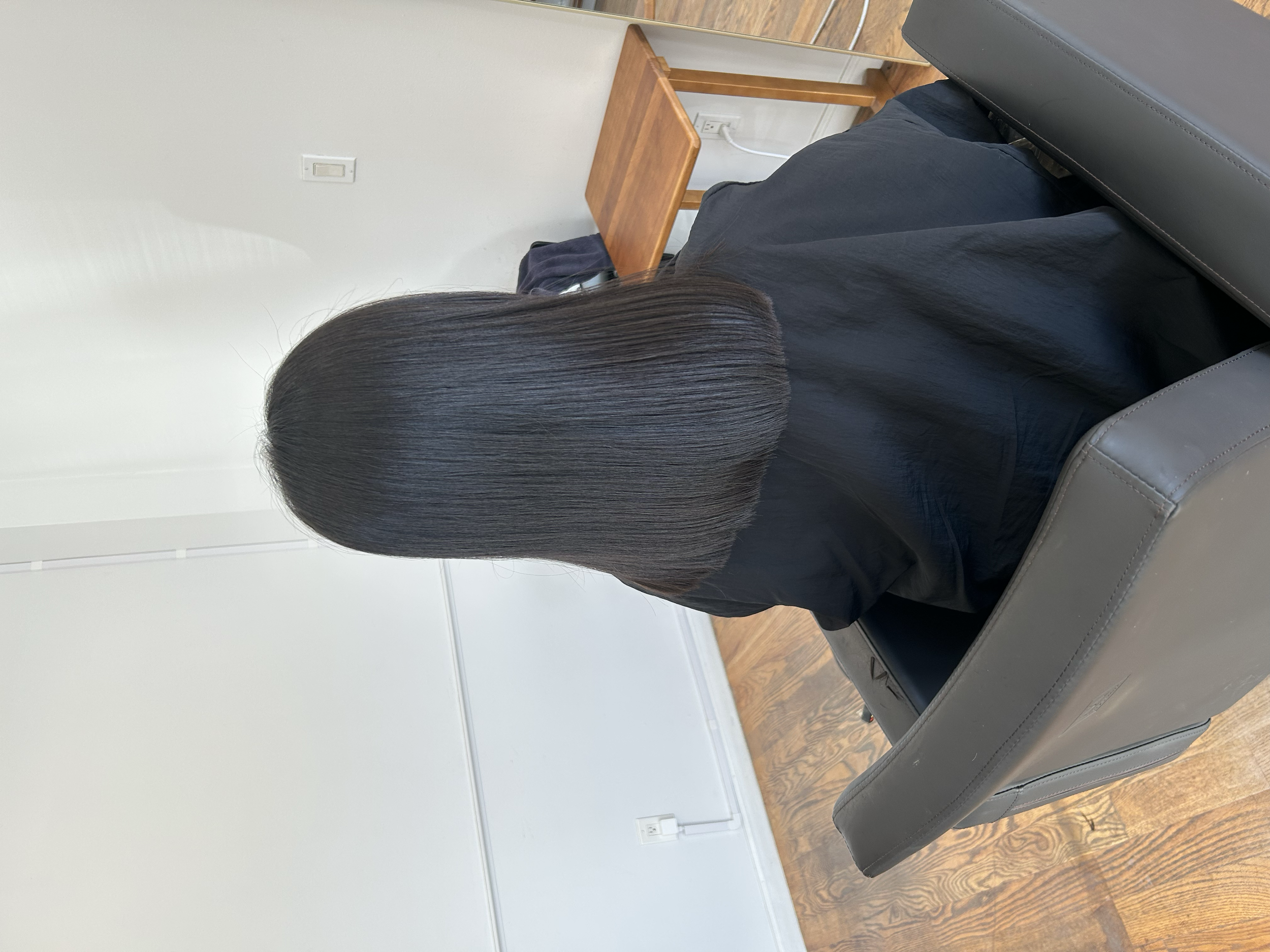 Smooth, dark shoulder-length hair with a sleek finish after HITA hair treatment at U&K Salon in Brooklyn.