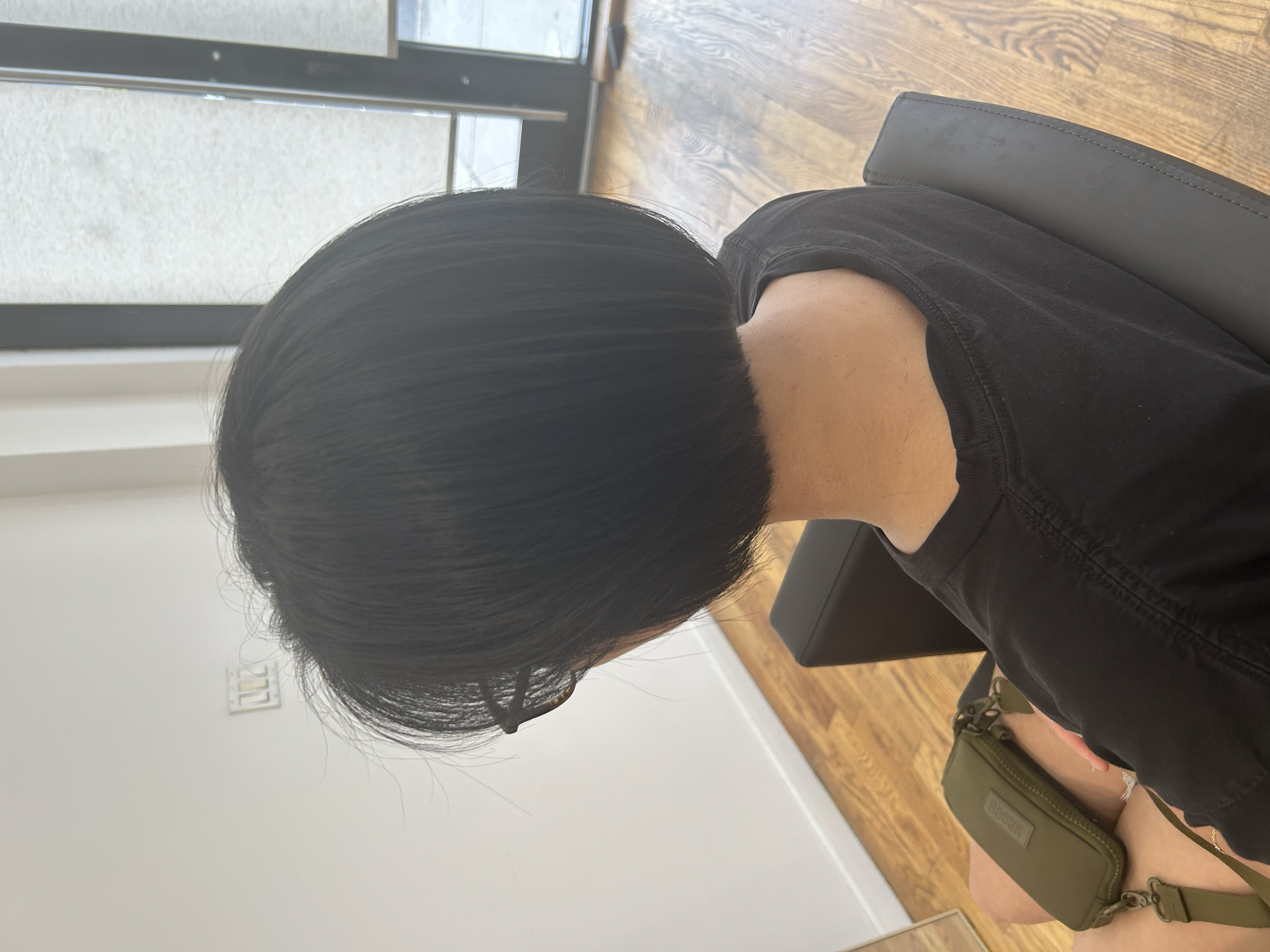 Short dark bob haircut with a rounded shape and precise neckline at U&K Salon in Brooklyn.