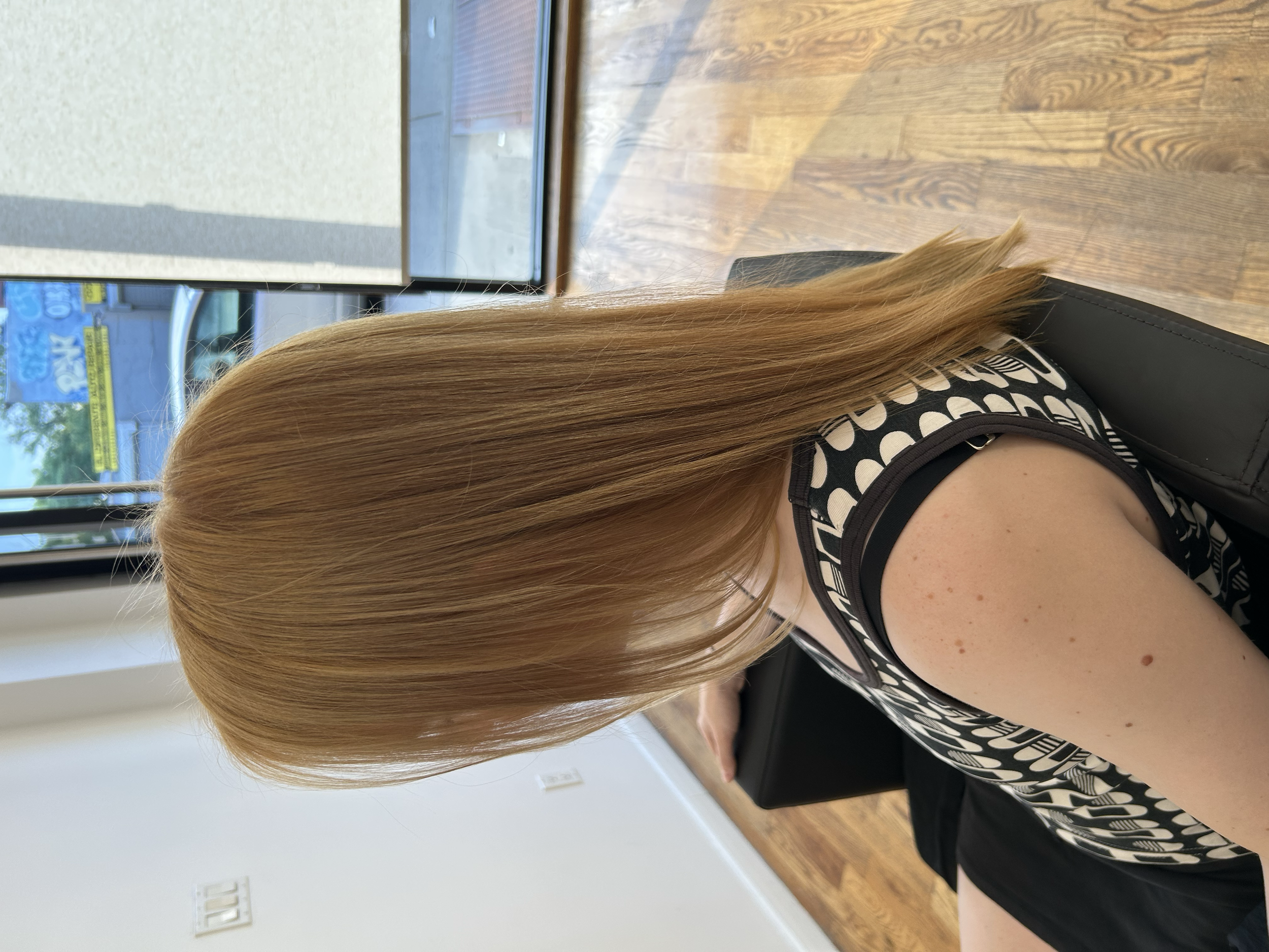 Golden blonde hair created with single process color at U&K Salon in Brooklyn.