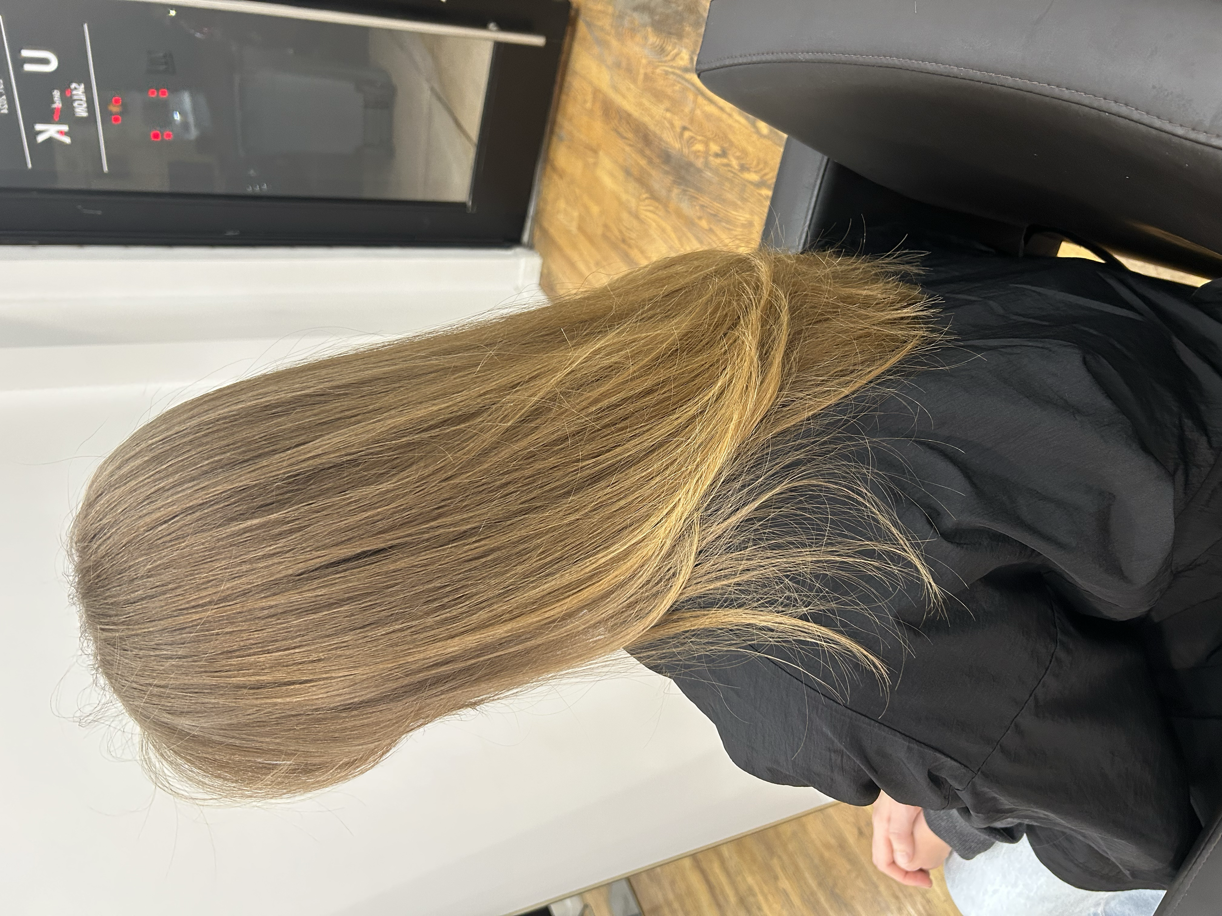 Long golden blonde hair with soft layers, photographed from behind at U&K Salon in Brooklyn.