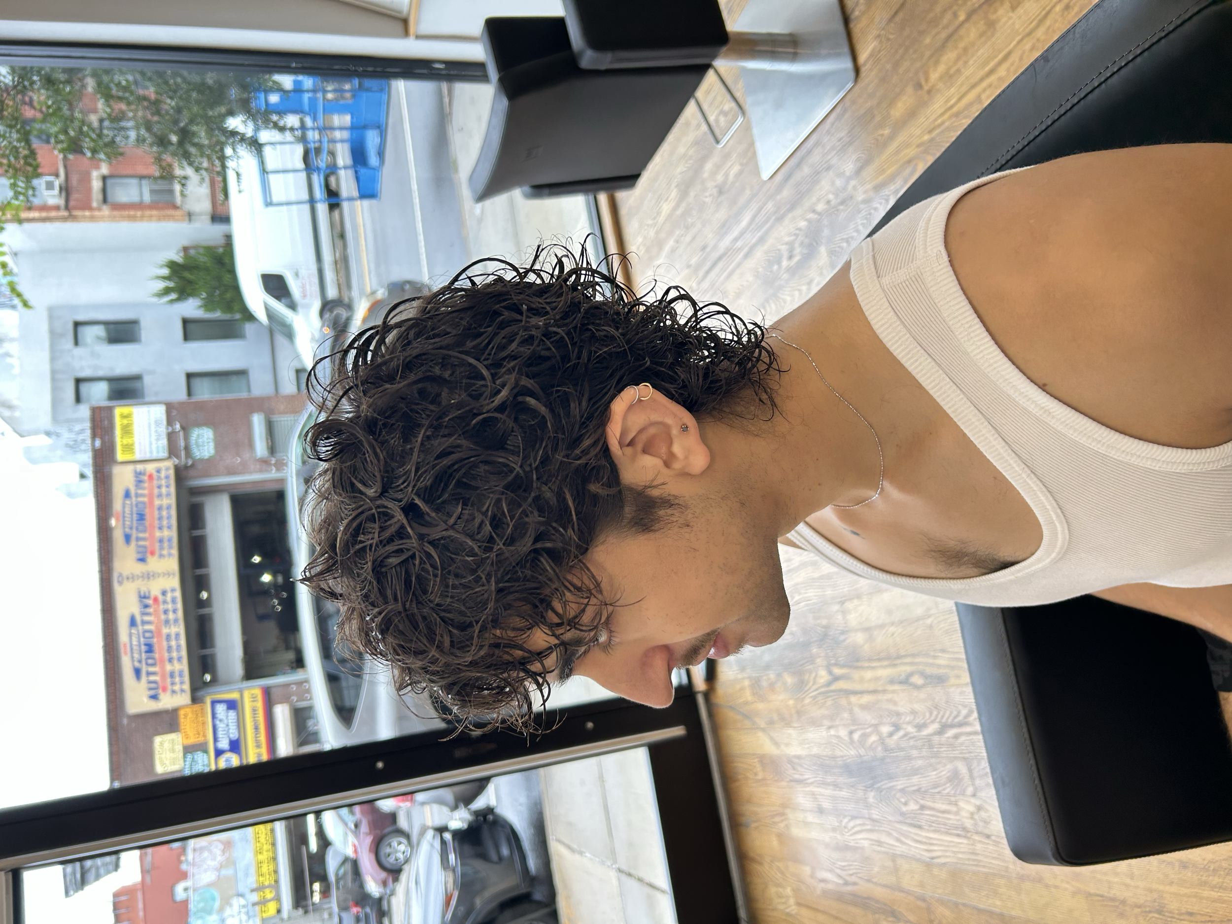 Medium-length men's wave perm with textured curls and natural movement at U&K Salon in Brooklyn.