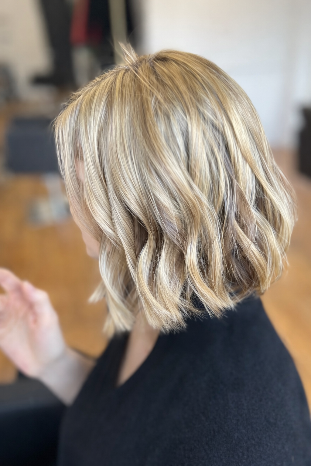 Shoulder-length wavy blonde bob with contrasting light and dark tones at U&K Salon in Brooklyn.