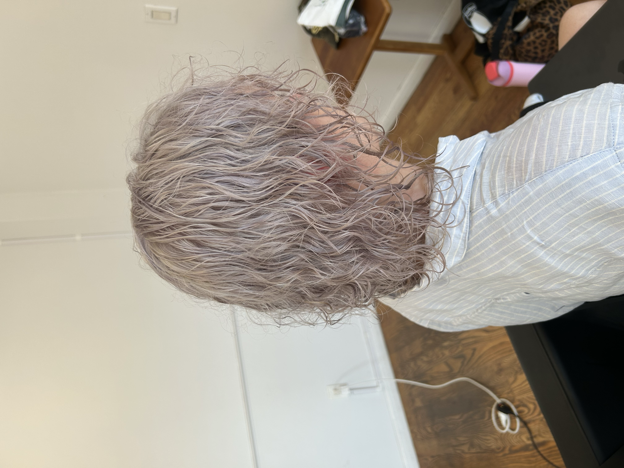 Shoulder-length wavy hair in a soft pink ash blonde shade at U&K Salon in Brooklyn.