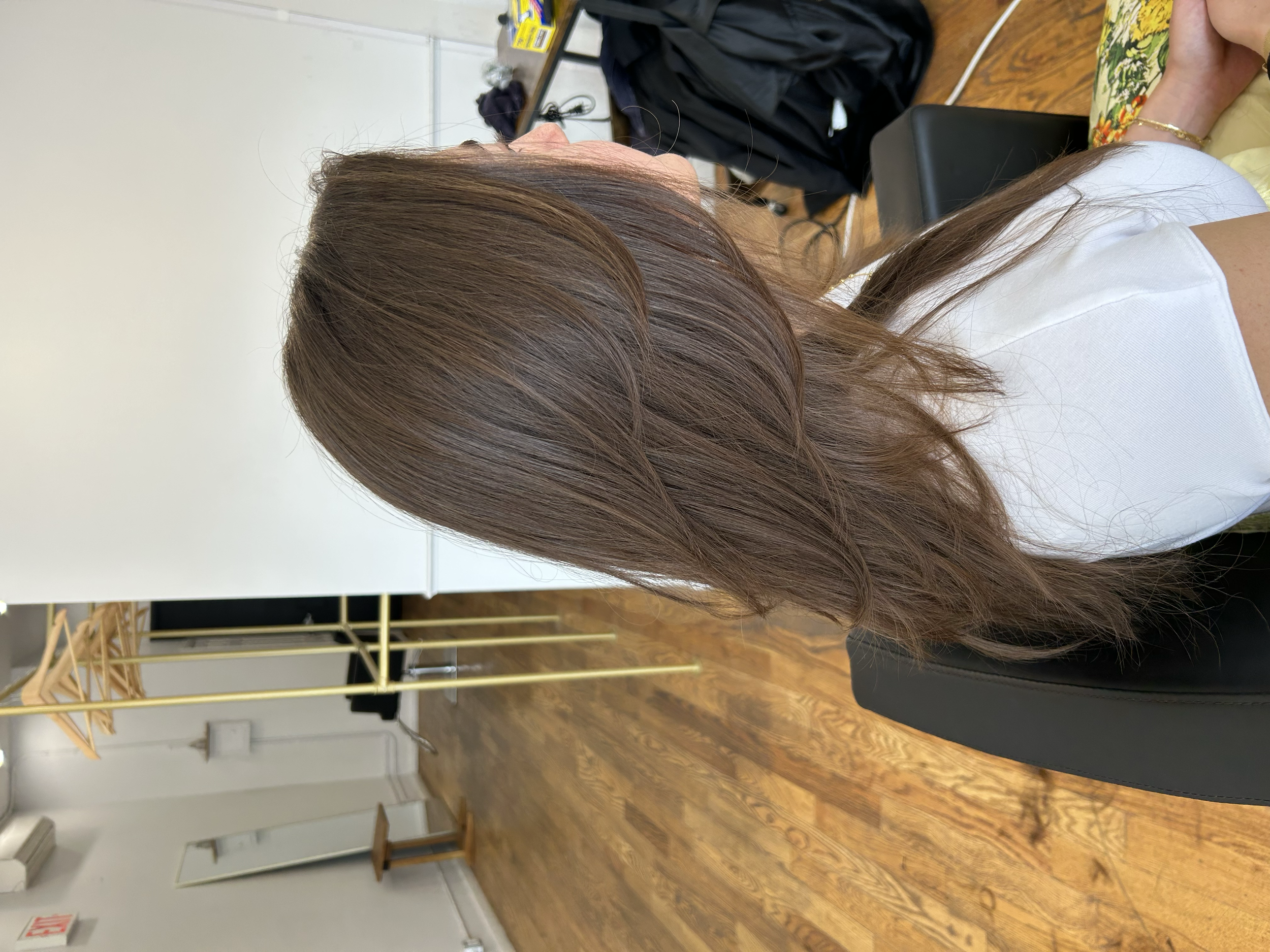 Medium-length soft brown hair with flowing layers and a natural finish at U&K Salon in Brooklyn.
