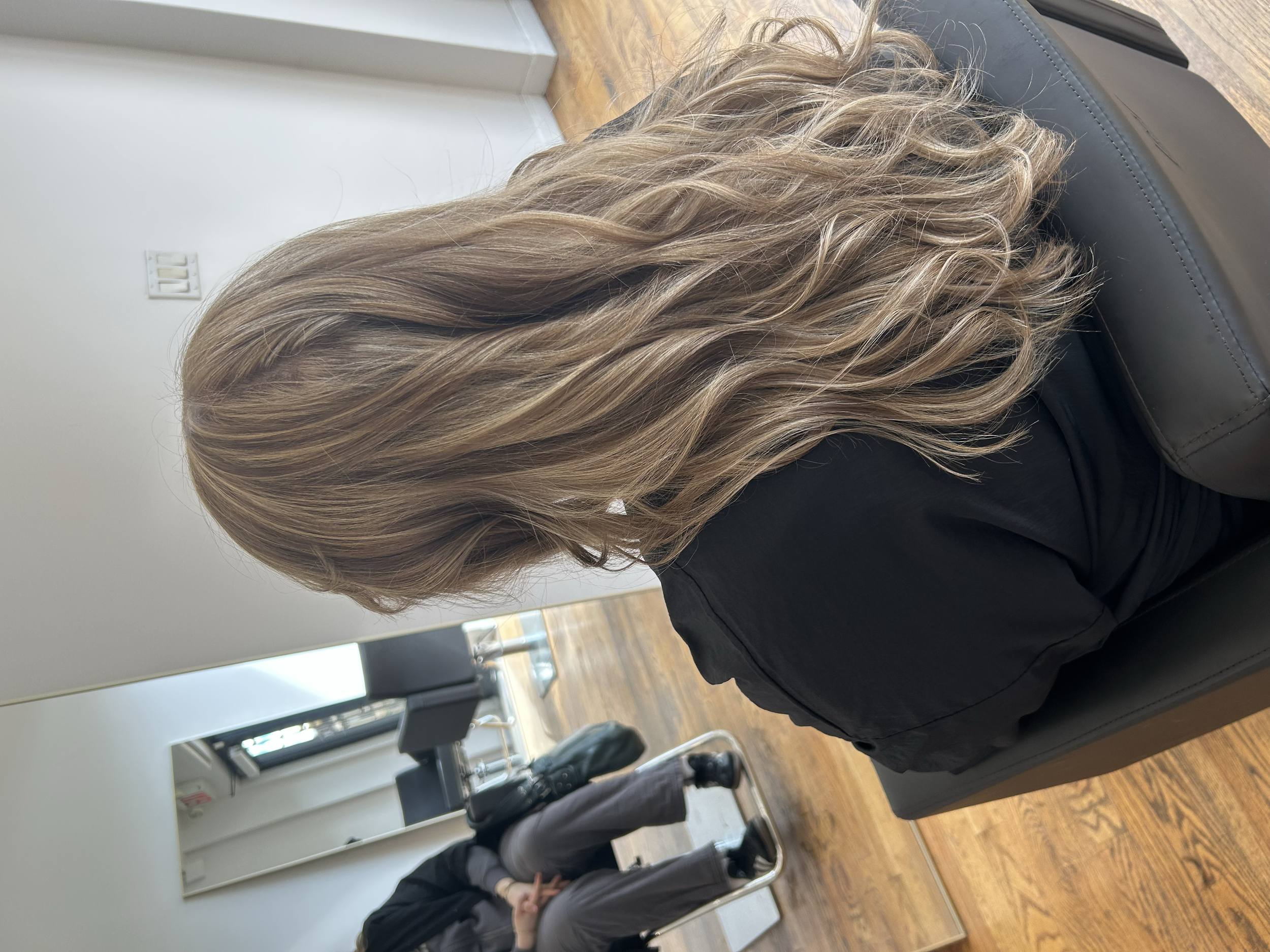 Long layered haircut with soft waves and dimensional blonde highlights at U&K Salon in Brooklyn.