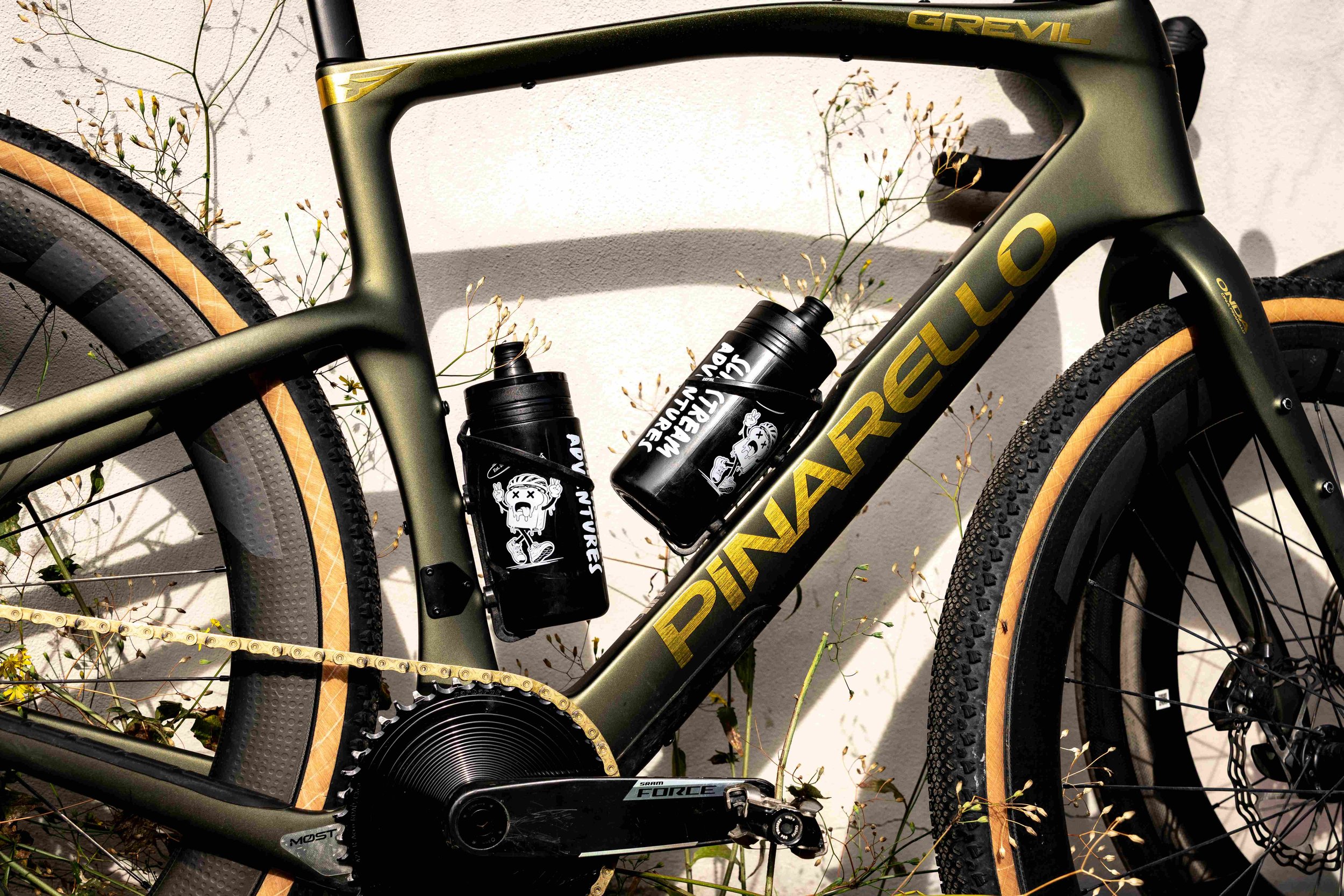 Pinarello Grevil F7 bike rental on the white gravel roads of Tuscany, with cypress trees behind