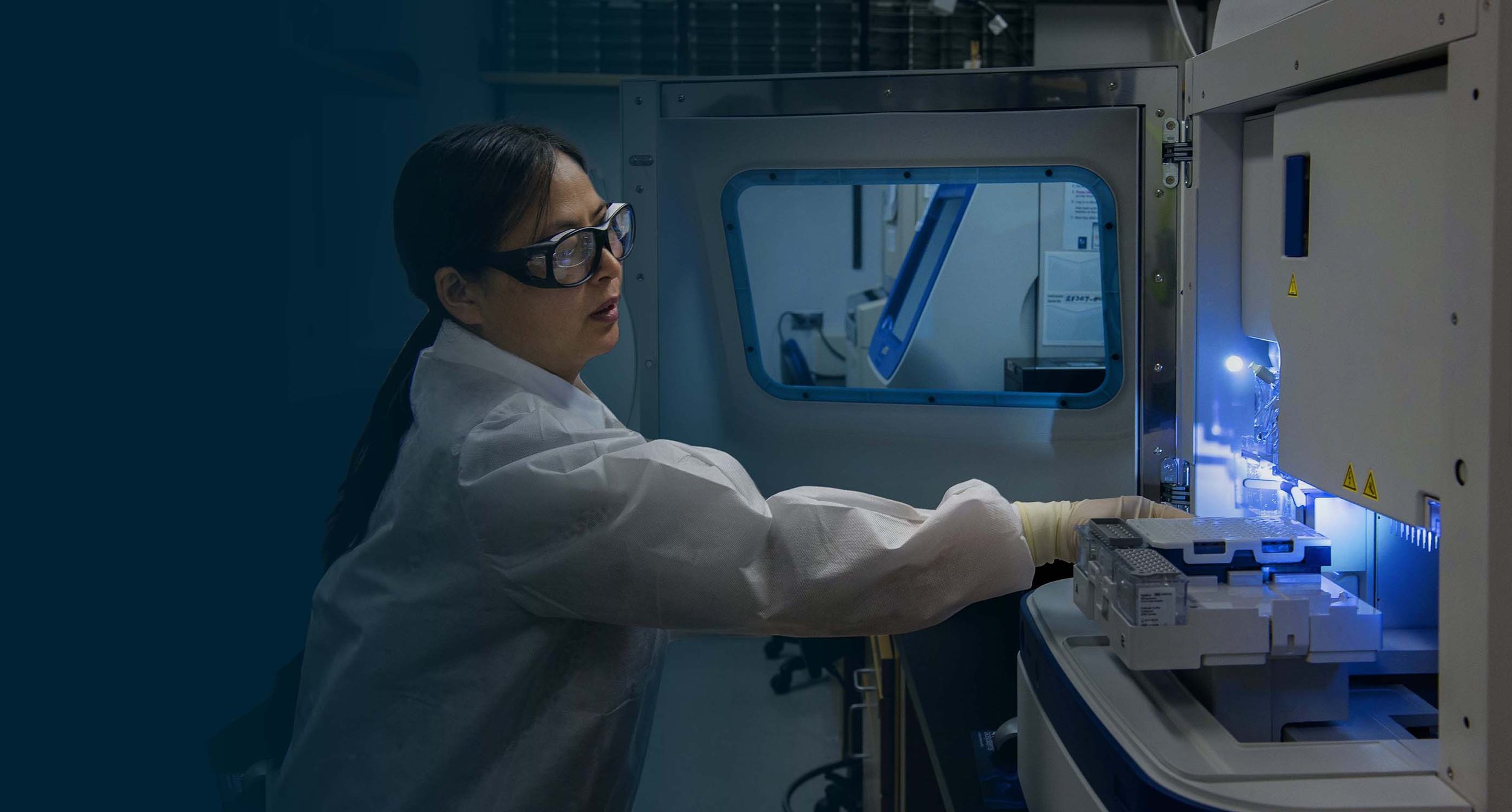 Laboratory employee operates a machine