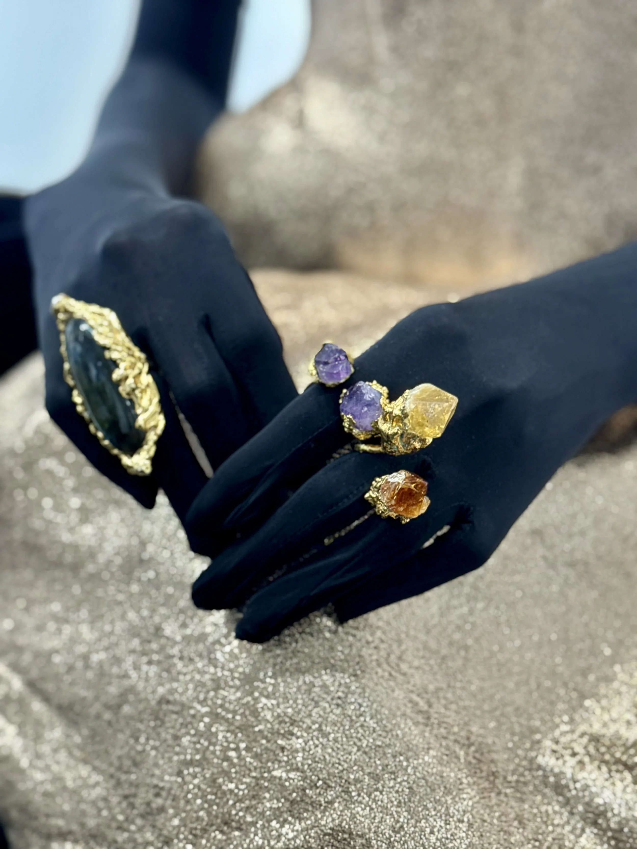 Close up of fashion model wearing Illumin Designs statement gold labradorite ring and amethyst and citrine rings in Padina Bonder gown during NYFW new york fashion week. dtr modern gallery.