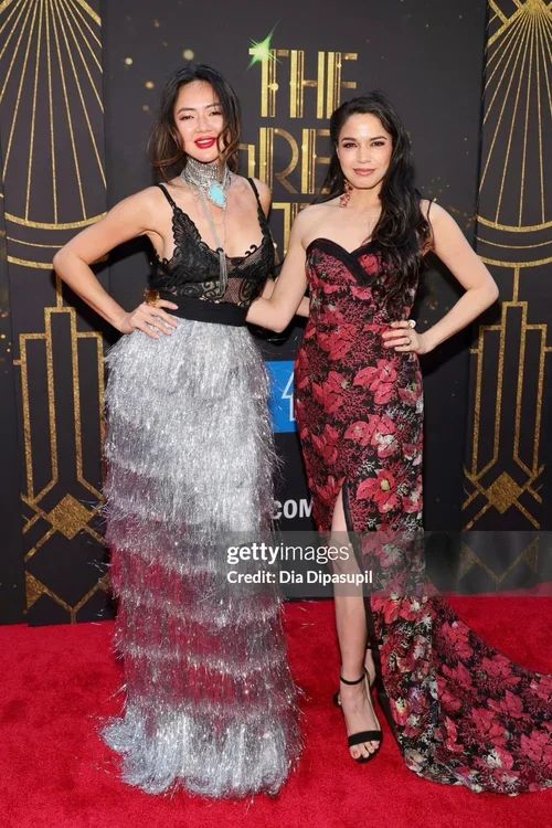 Angel Pai and Arielle Jacobs wearing elegant and glamorous Malan Breton gowns posing on a red carpet at of the Great Gatsby Broadway premiere event.