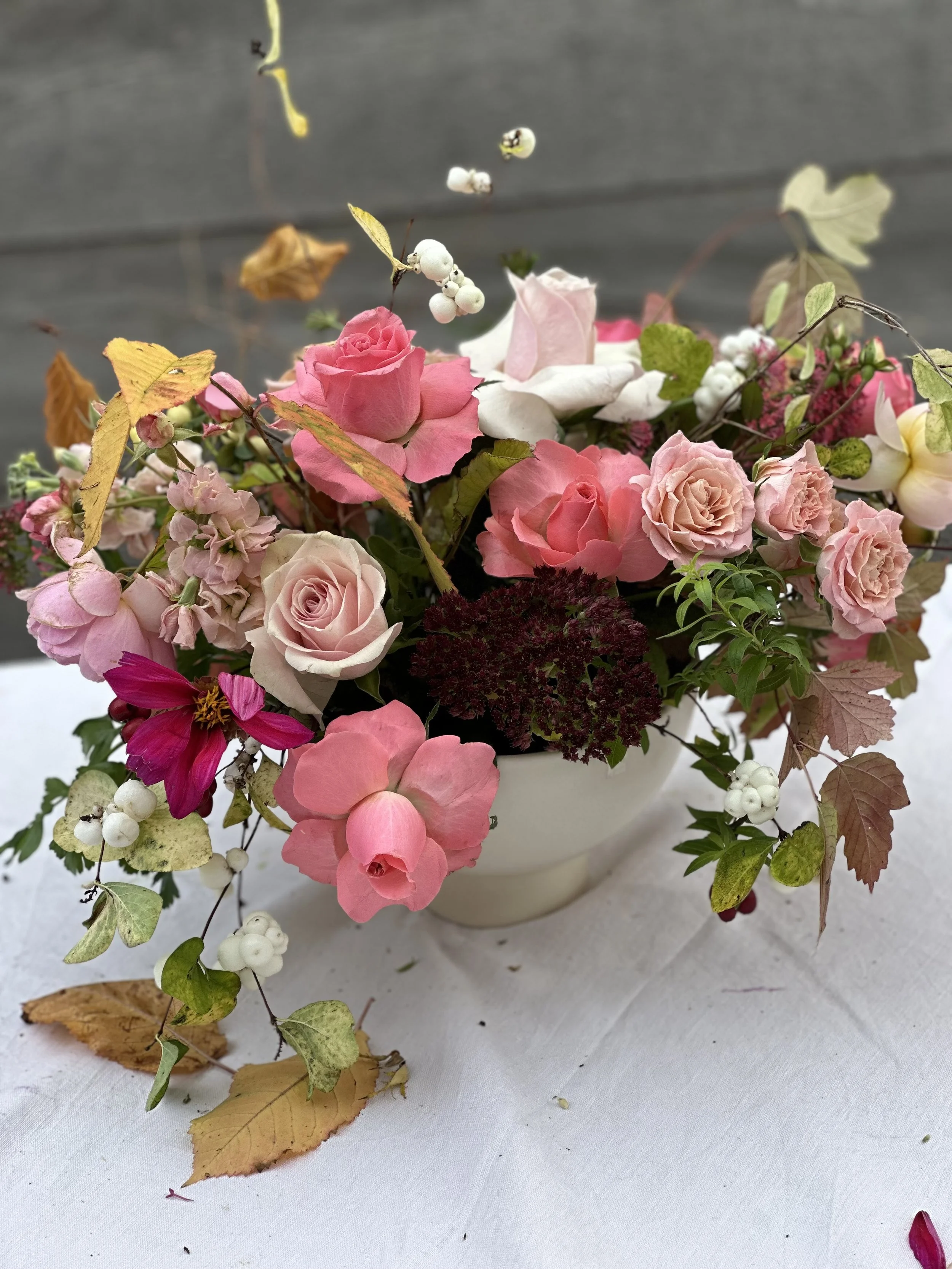 Autumn centrepiece with pink and blush roses, beech leaves, snowberries, and hawthorn by Foxgloves & Roses