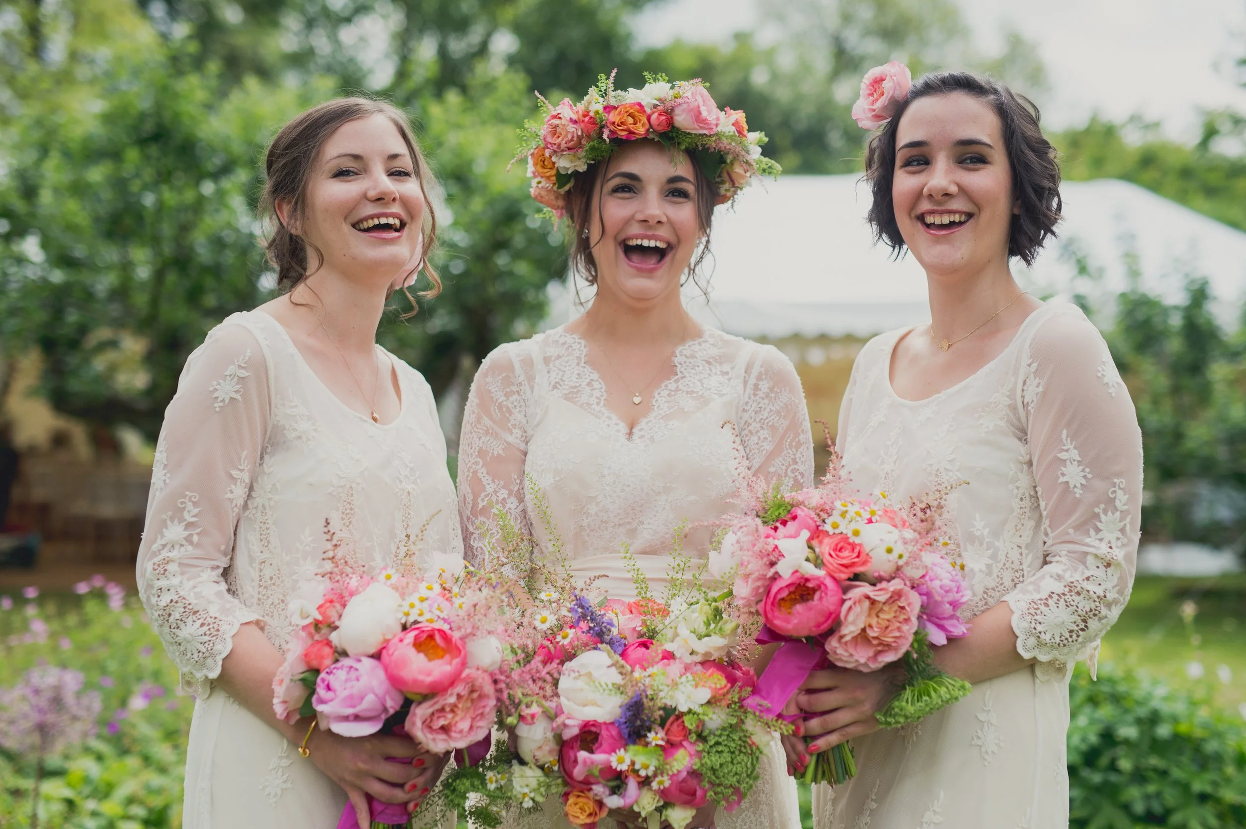 Bride and bridesmaids with vibrant summer bouquets and flower crown, Foxgloves & Roses floral design.