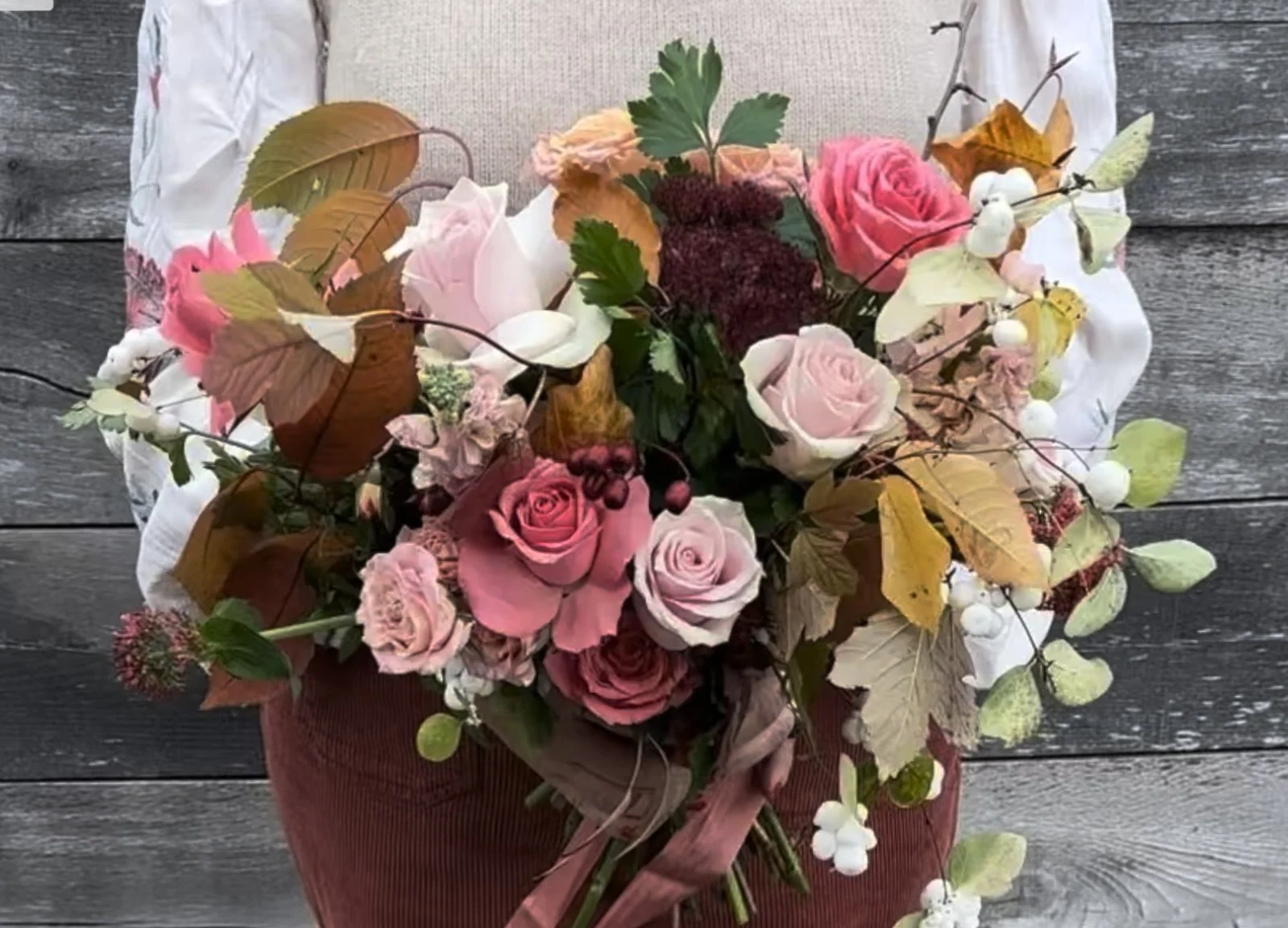 Autumn bouquet with pink and blush roses, beech leaves, snowberries, and hawthorn by Foxgloves & Roses