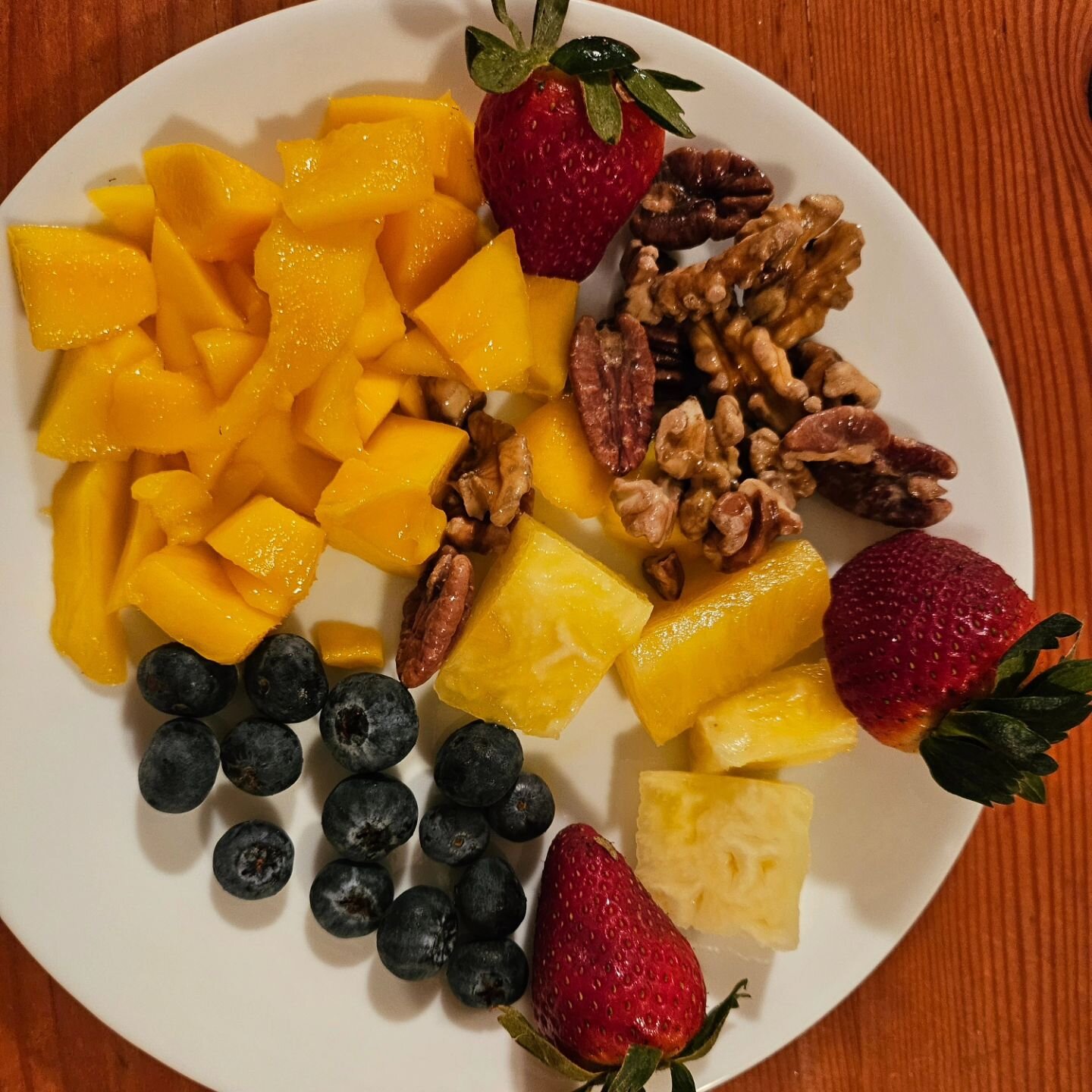 The breakfast of champions. Local blueberries, strawberries, pineapple, and mango with soaked walnuts and pecans.