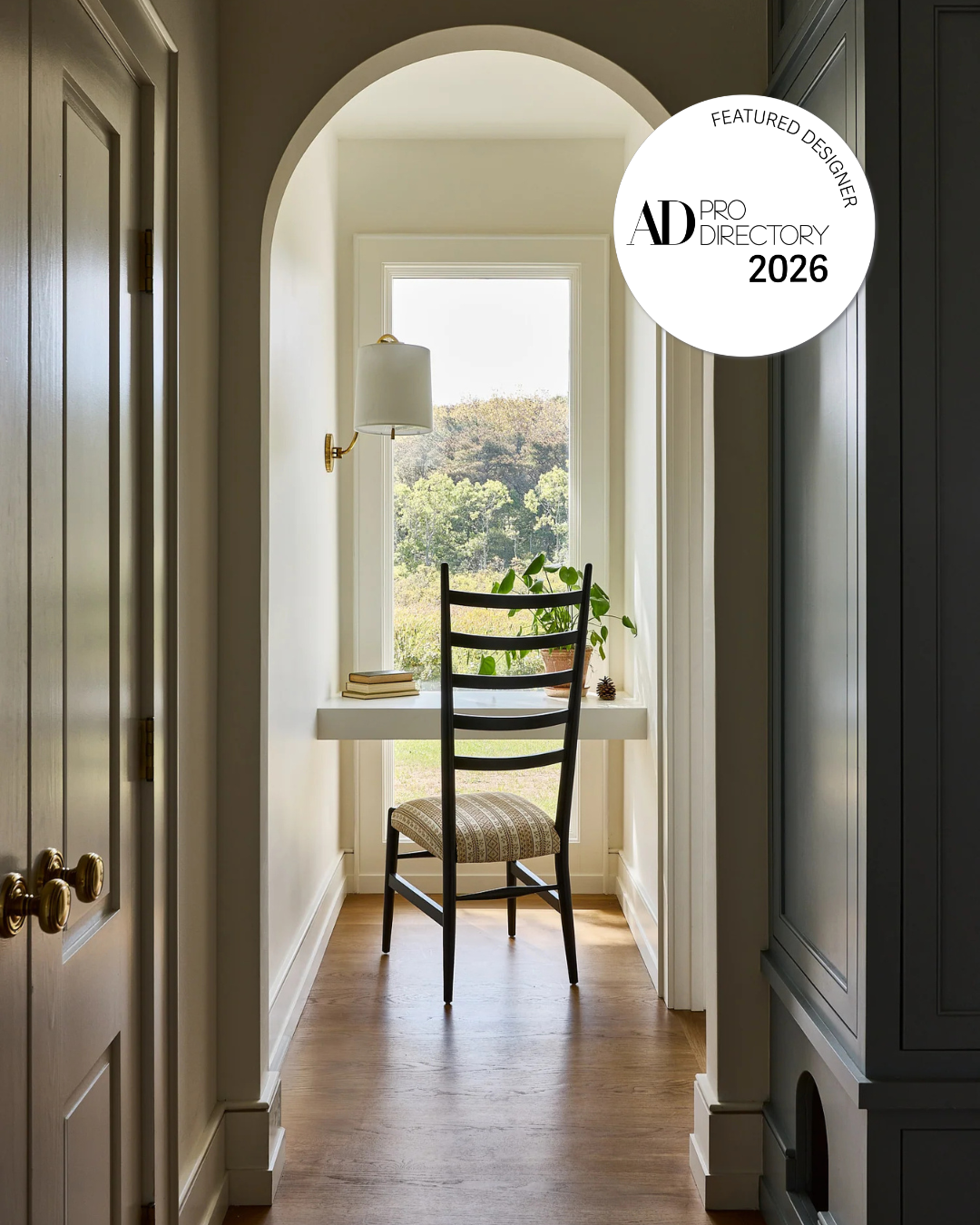 Mackenzie & Co. AD PRO Directory 2026 badge over an arched hallway in a North Truro, Cape Cod home.