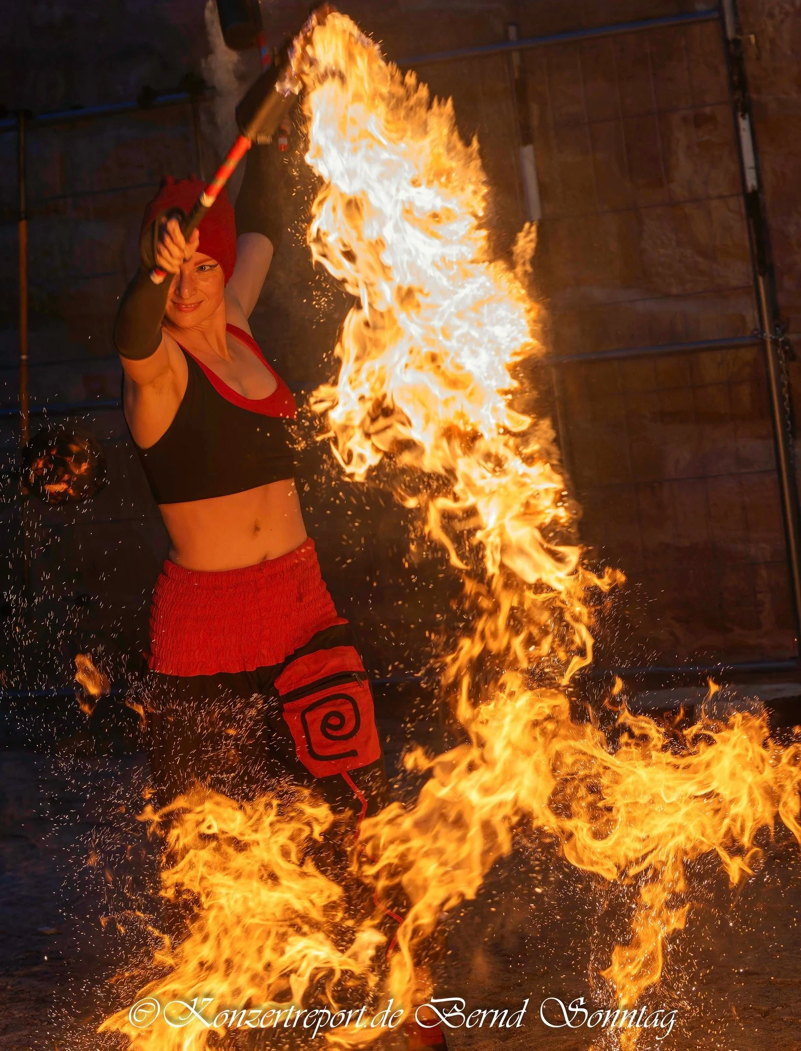 Elena Tinkloh swinging lyco torches counterclockwise — flow arts performance