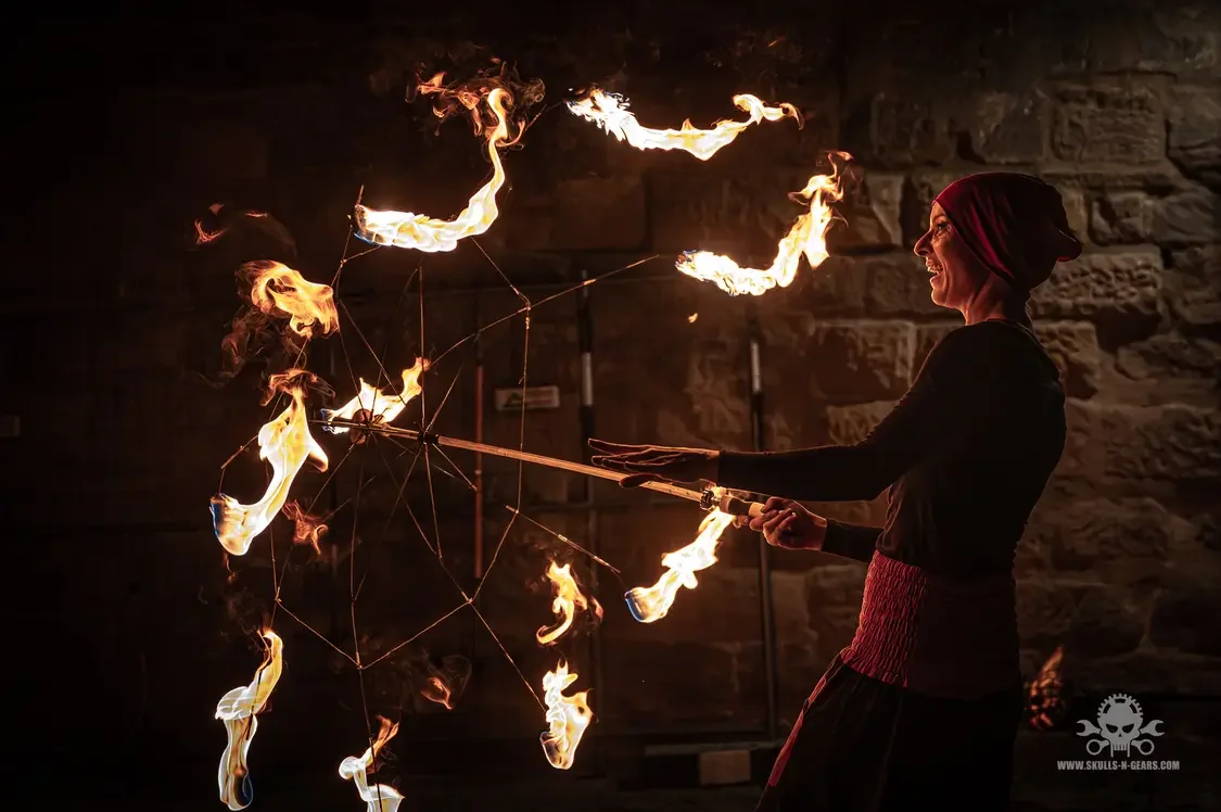 Elena Tinkloh performing with a fire umbrella at night — flow arts and psychology