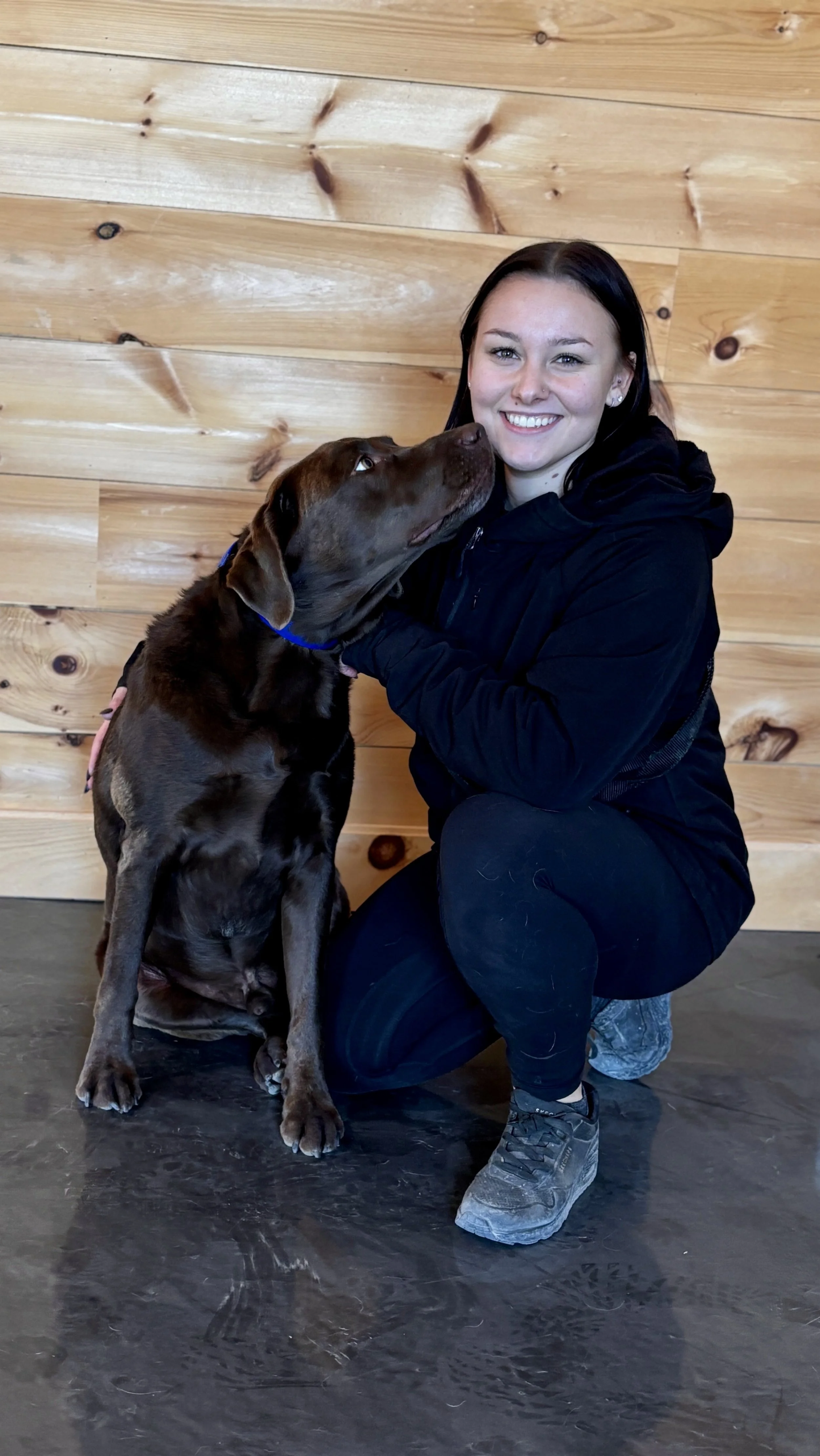 Cassie, wedding dog attendant with Black Dog Weddings, providing dog care during a wedding day.