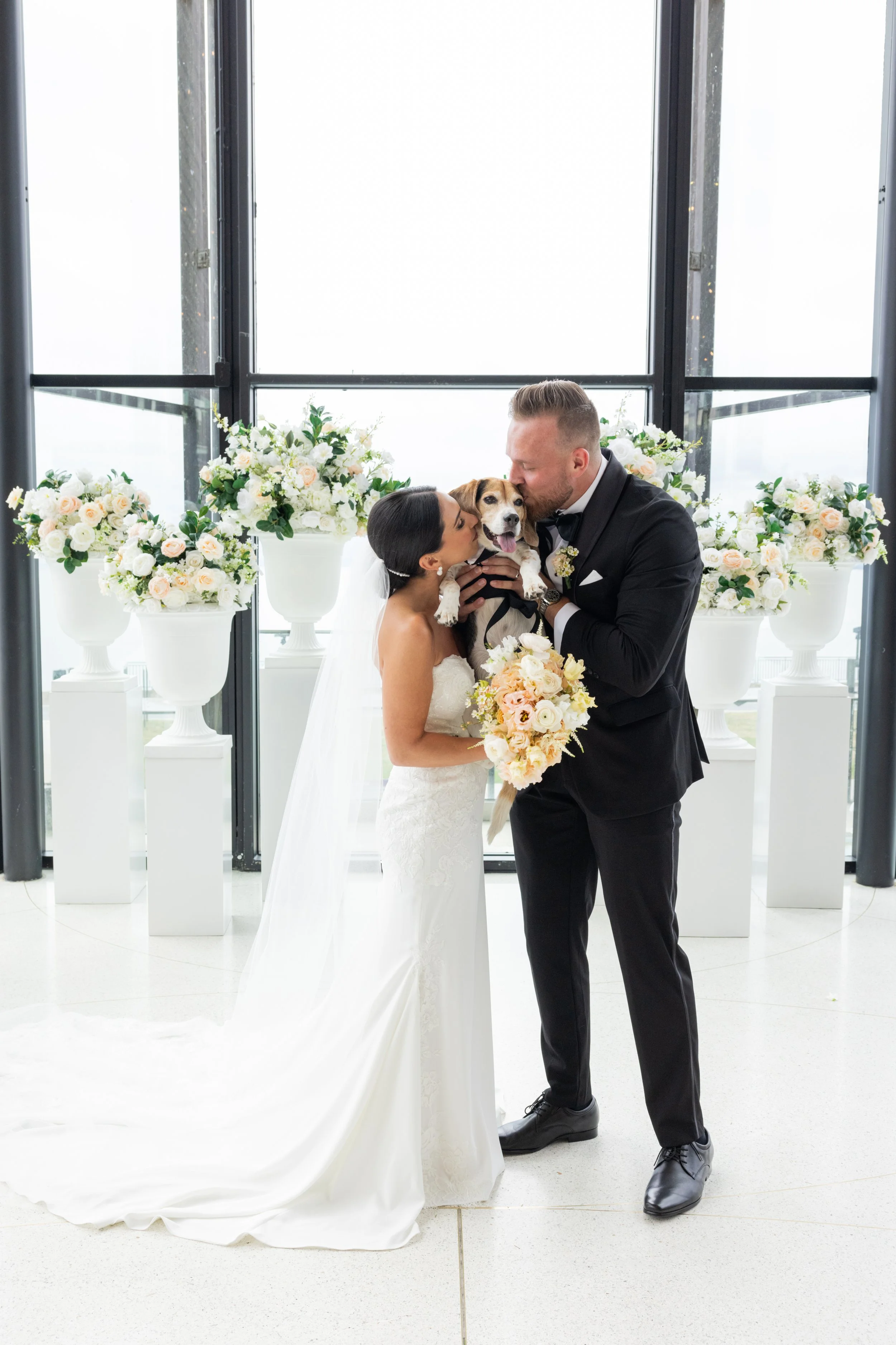 It's a beagle sandwich! Mack soaking up all the kisses from is parents at Spencer's on the waterfront with Black Dog Weddings. Photography credit Canan Studio