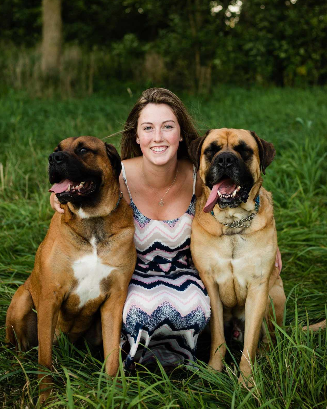 Kelcie, wedding dog attendant with Black Dog Weddings, handling a dog during a wedding event.