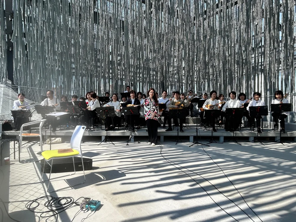 Ana alongside the 30 musicians of the ensemble conducted by Mr. Yoshida.