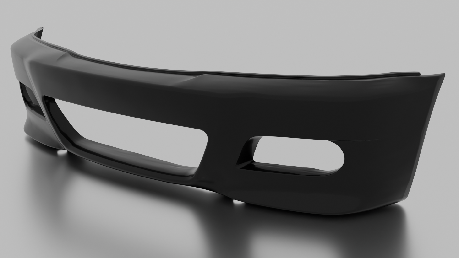 Black car bumper on a light gray surface.
