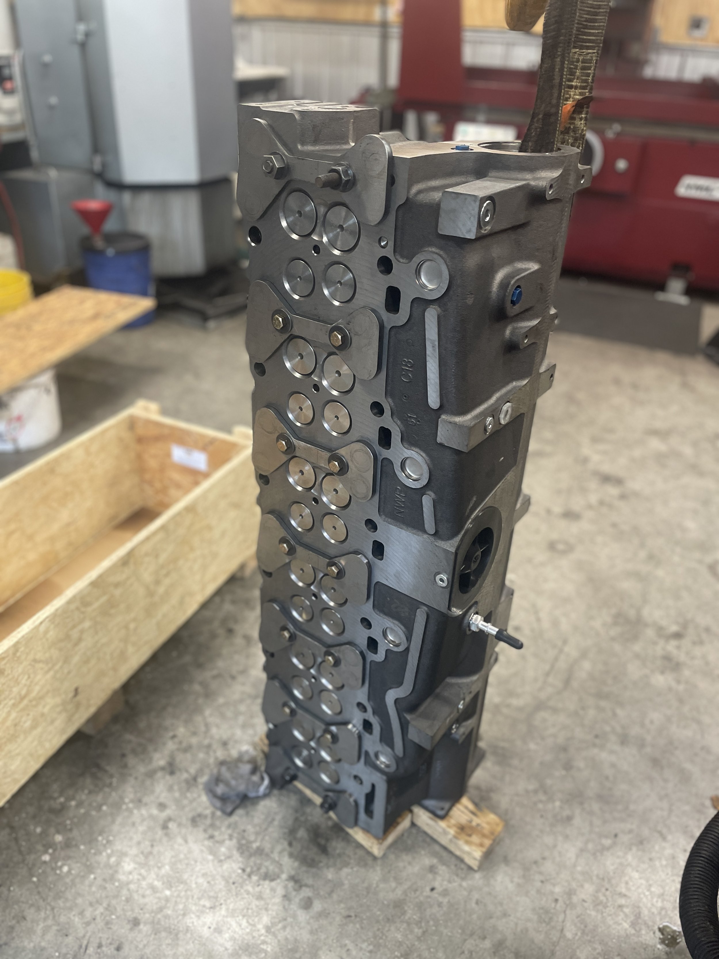 Pressure testing Caterpillar C15 cylinder head for cracks or leaking injector sleeves cups tubes