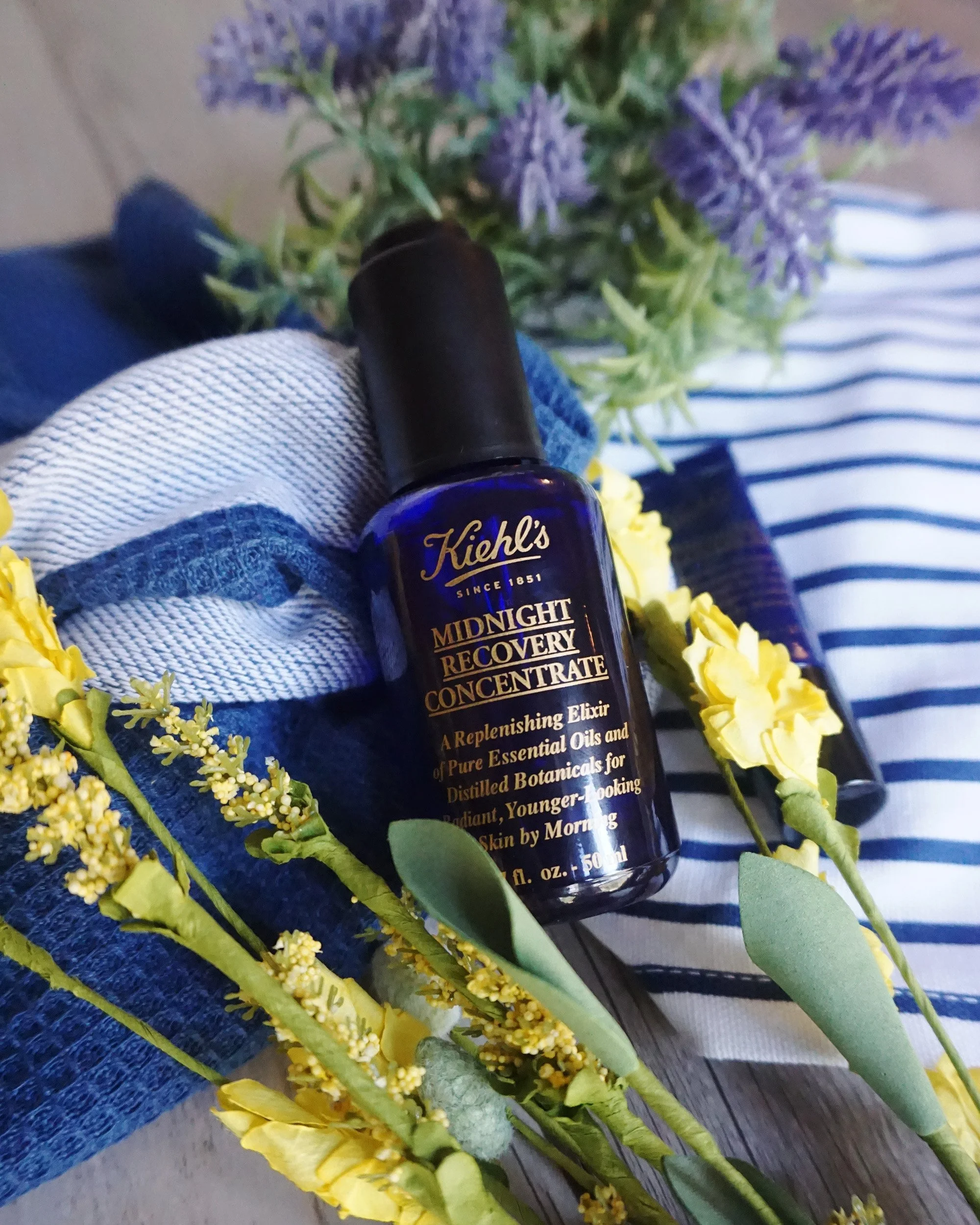 Photo of a blue skincare bottle on flowers taken by product photographer Melanie Richtman