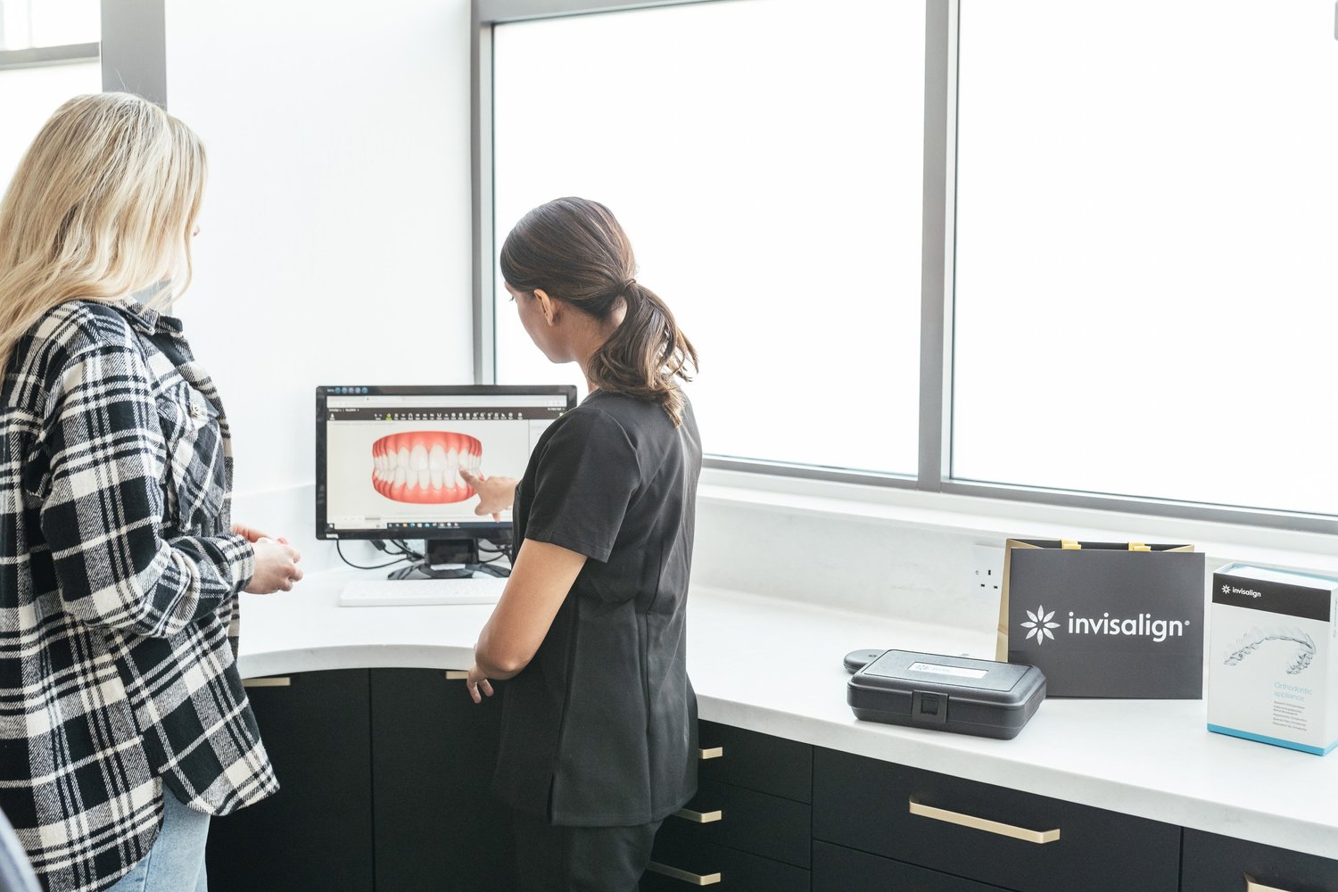 A patient discussing a digital Invisalign smile plan during a dental consultation