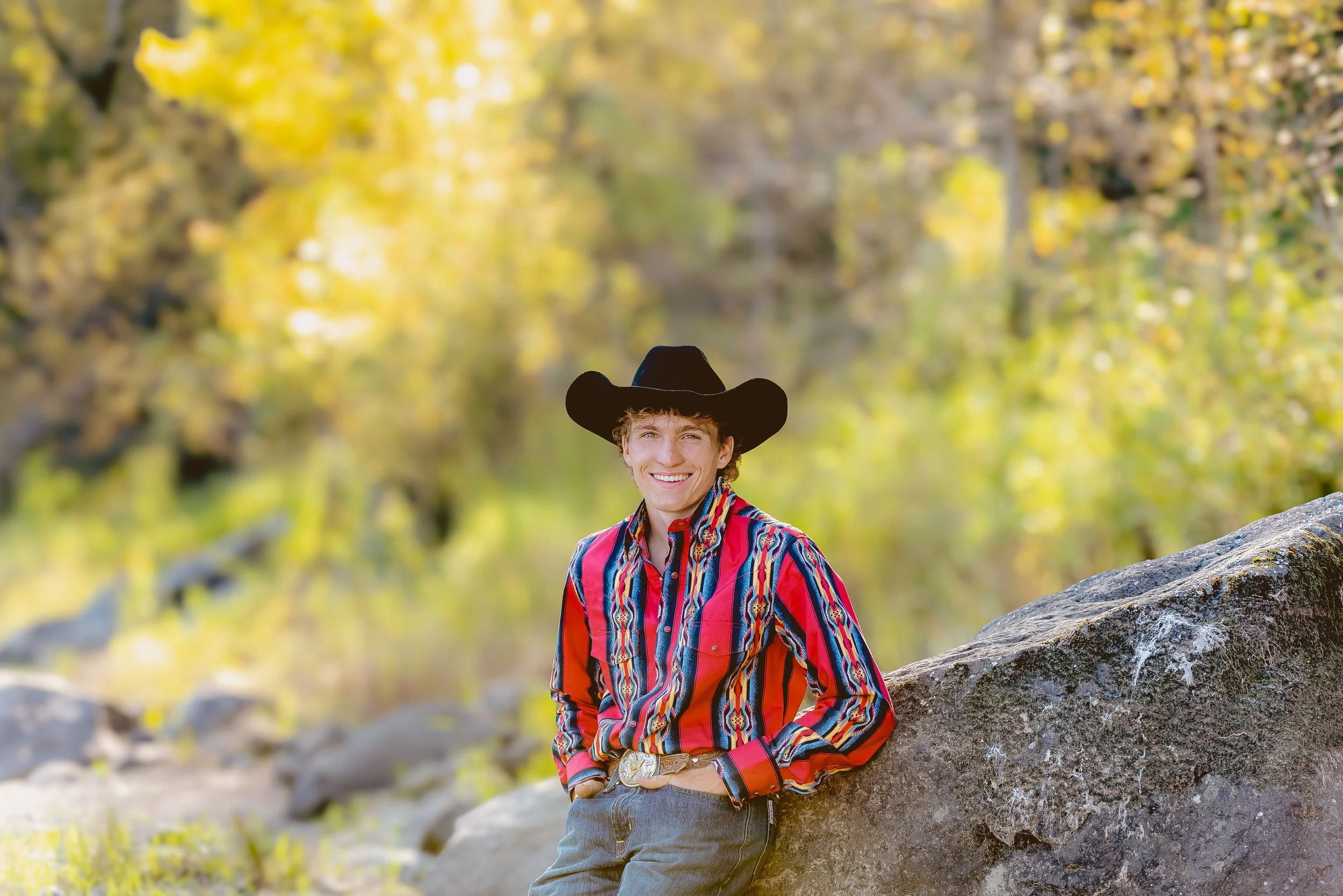 High school senior boy wearing cowboy hat and western outfit posing confidently during senior photo session in Vancouver Washington