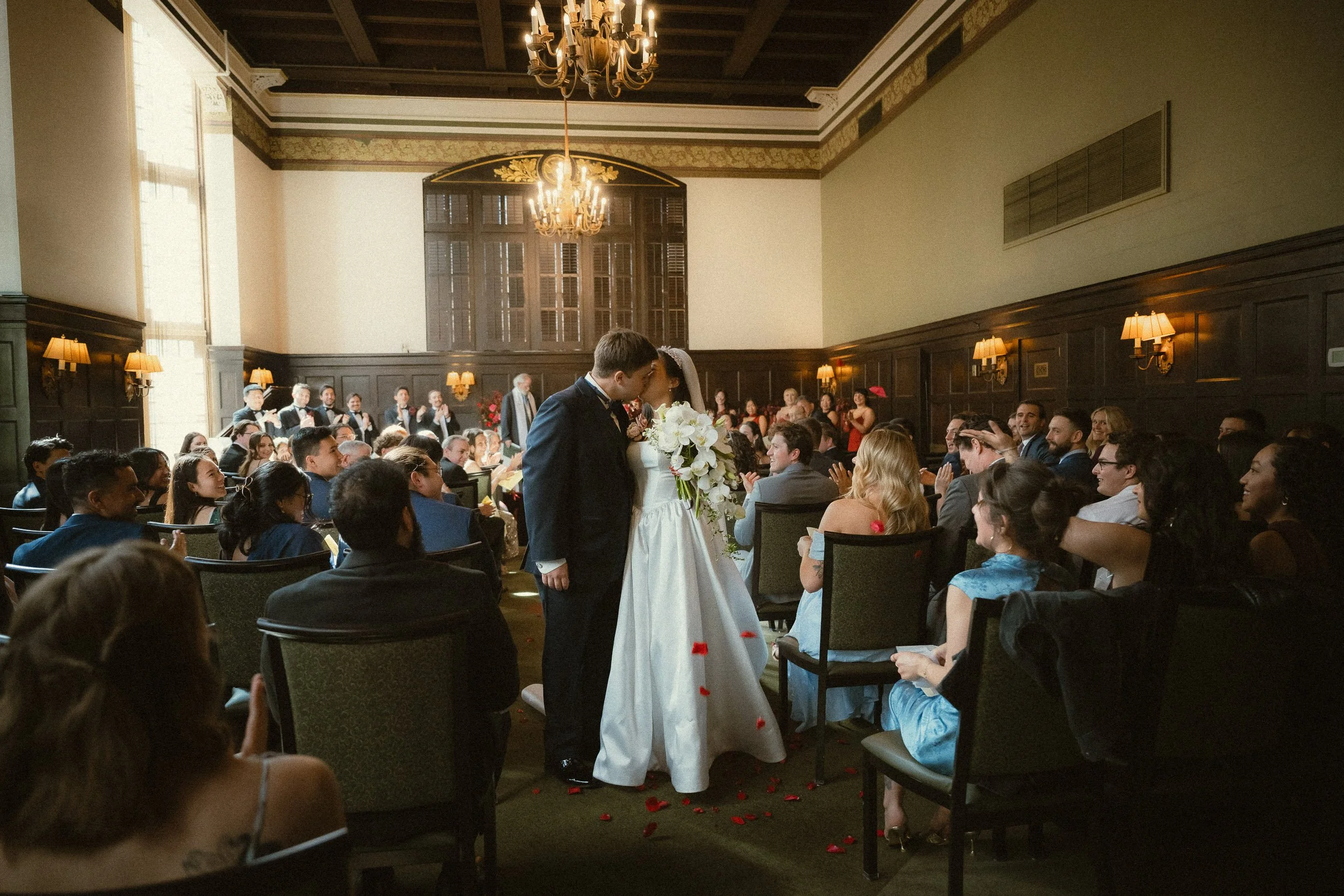 Bride and groom final exit inside the University Club of Portland ballroom during wedding reception with romantic lighting, celebration, and elegant downtown Portland wedding atmosphere