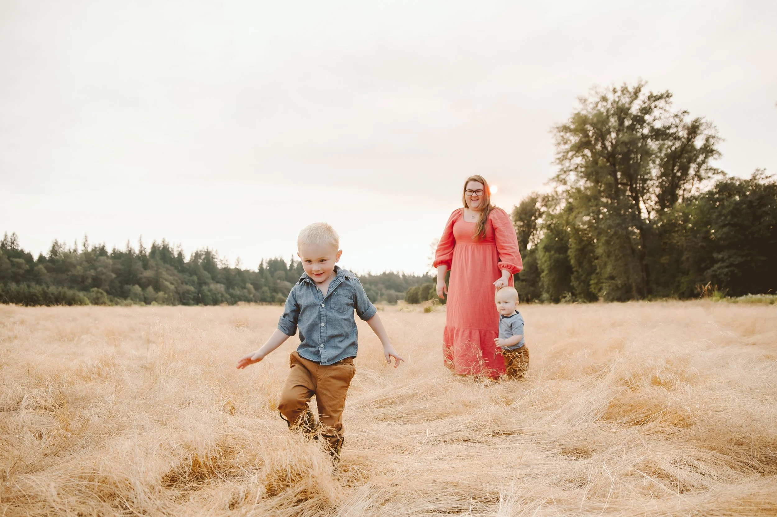 Mother laughing with young children during an outdoor family photo session in Vancouver Washington