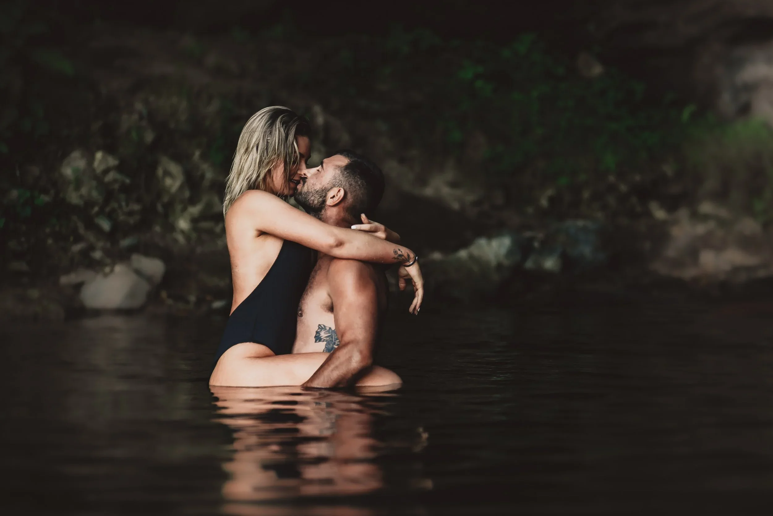 intimate couple embracing in water during an adventurous oregon elopement session natural emotional moment