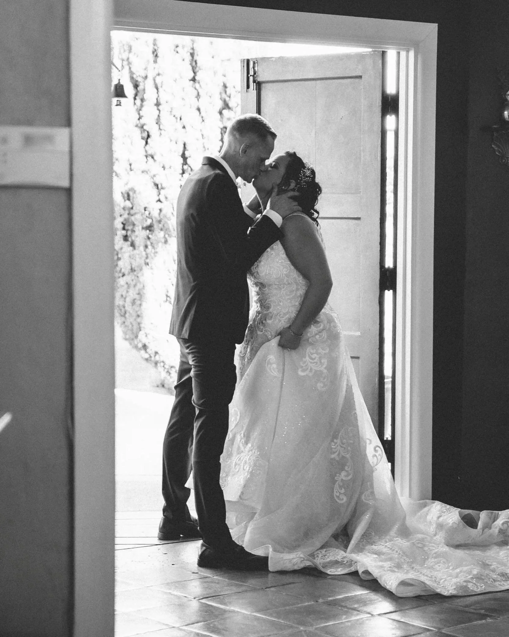 Black and white wedding photos always hit a little differently.

Without the color, your eye goes straight to the shape of the moment: the way they&rsquo;re standing, the light in the doorway, the dress on the floor, the quiet pause before the day ke