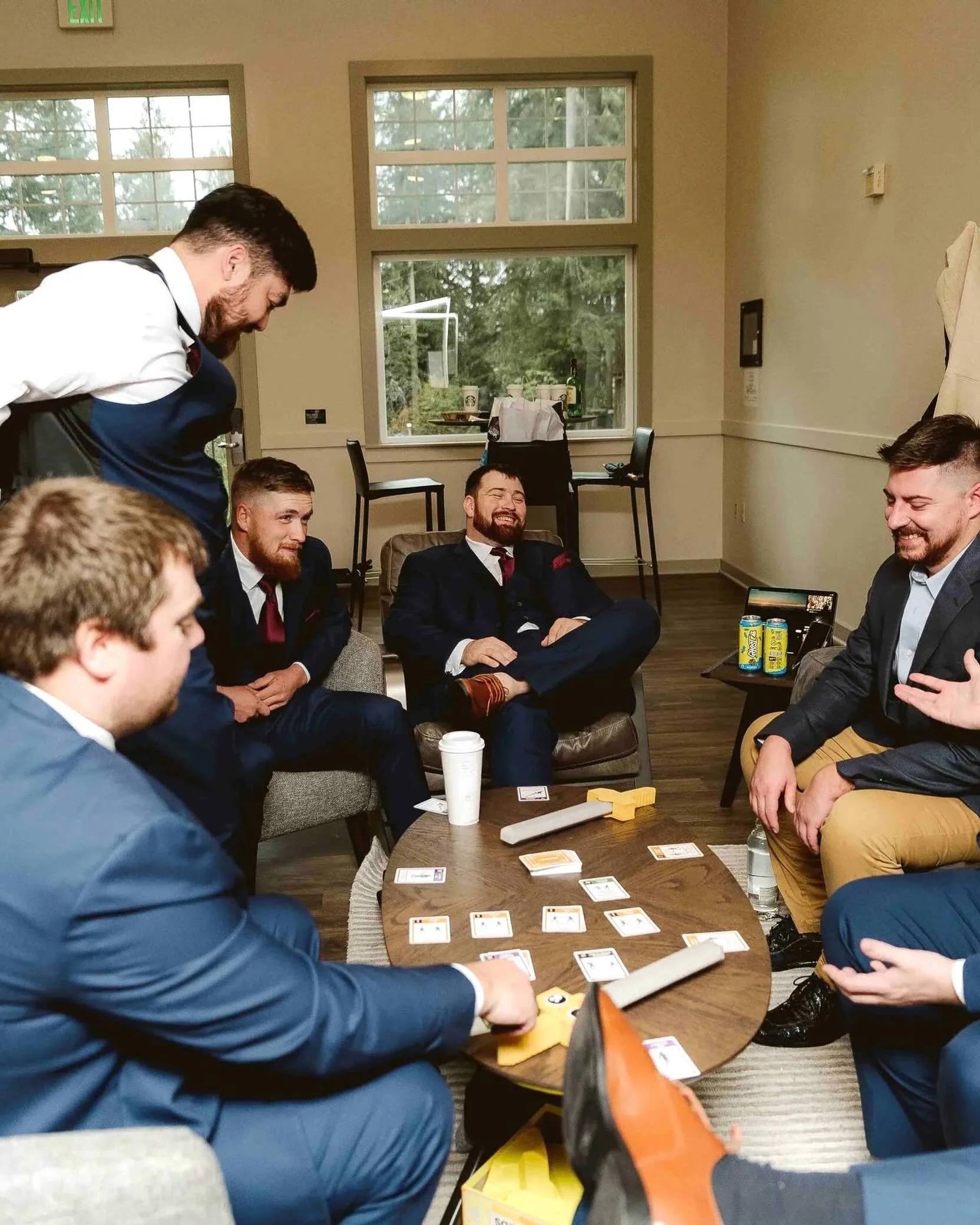 The getting ready part of a wedding day does not always look quiet and polished.

Sometimes it looks like card games, snacks on the table, half-finished drinks, jackets hanging on the wall, and everyone trying to stay loose before the ceremony starts