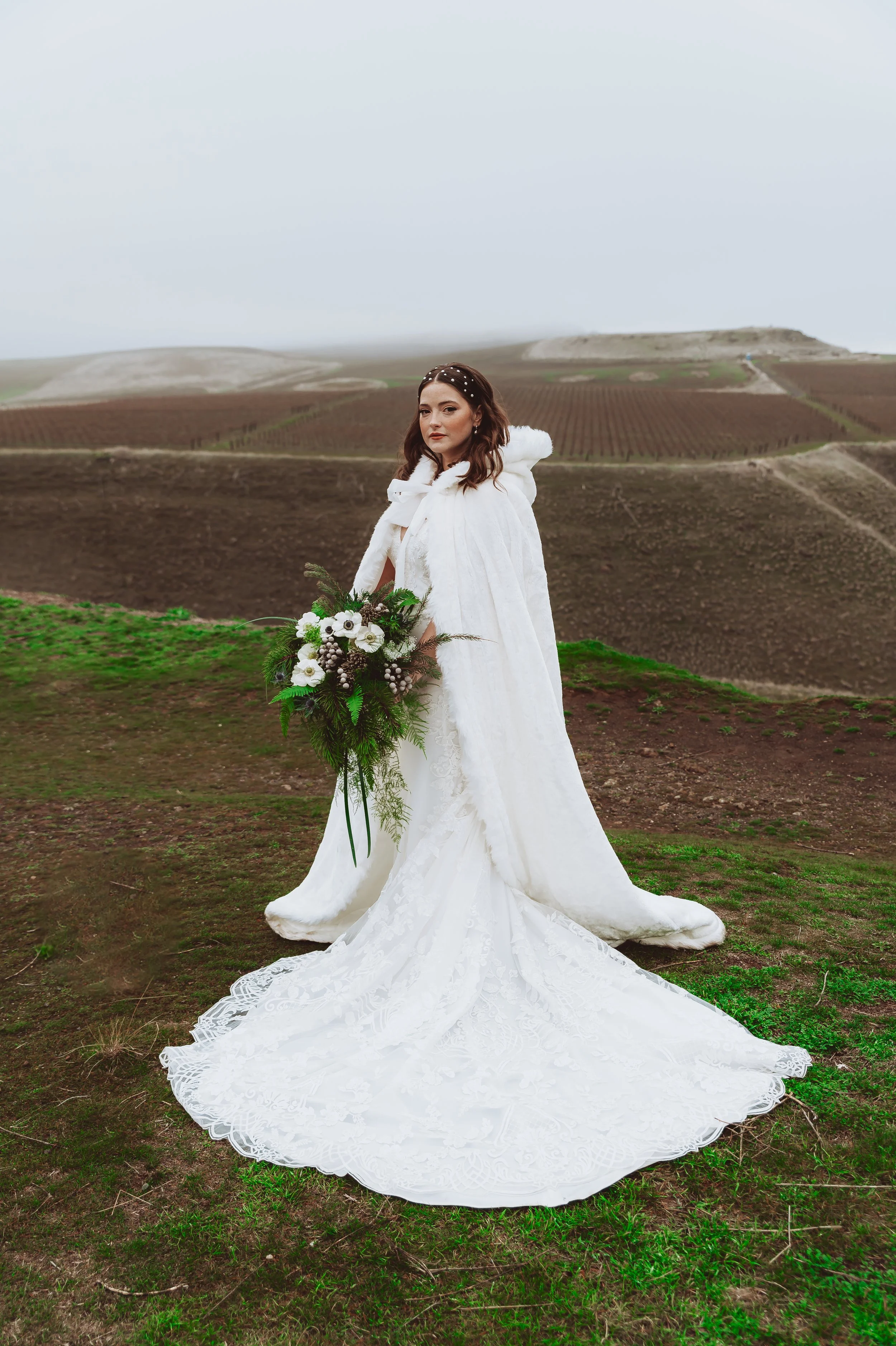Bride standing in an open Pacific Northwest landscape during an intimate elopement portrait session.