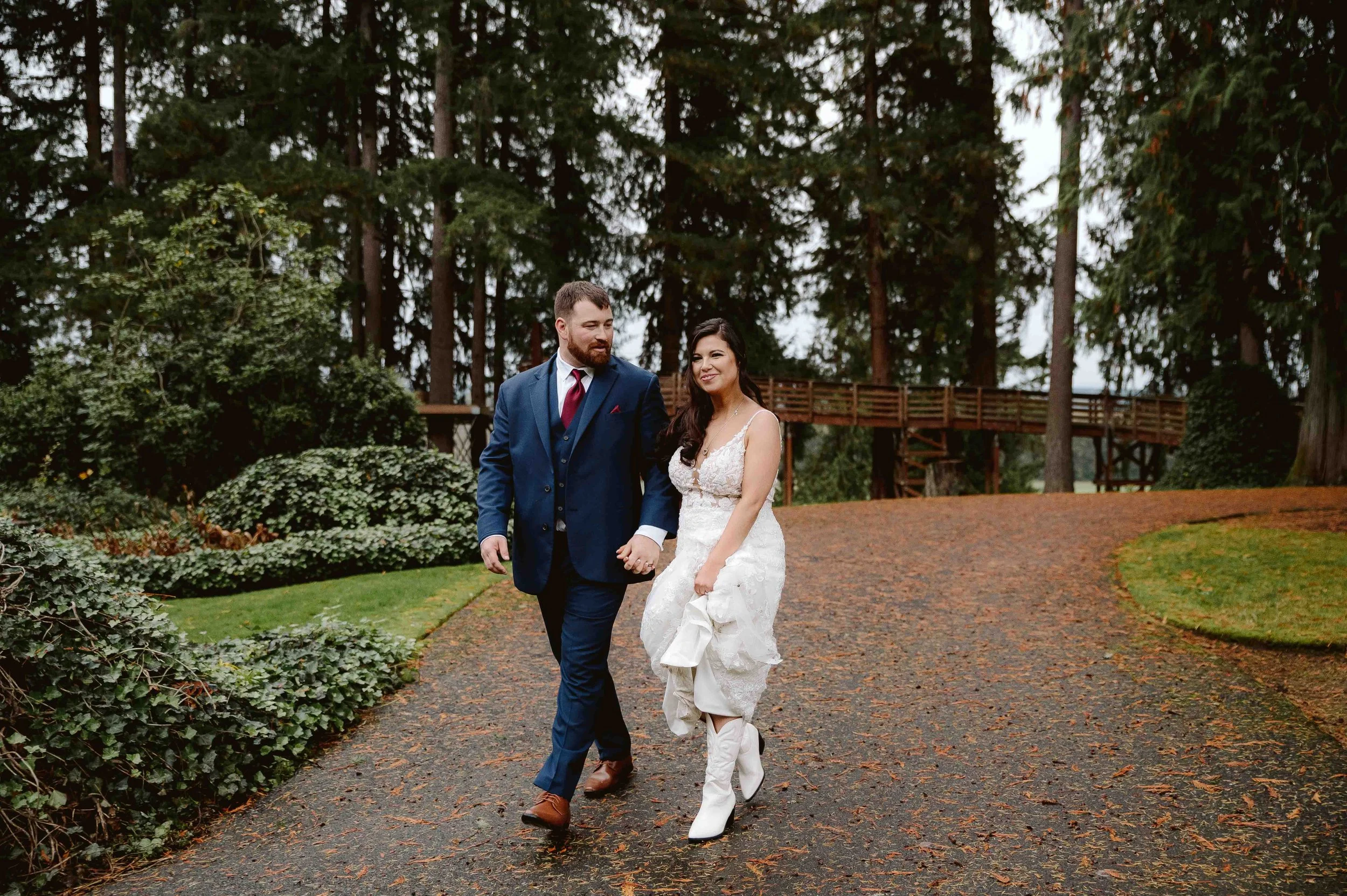 bride wearing cowboy boots during rainy oregon adventure elopement with practical outdoor wedding style