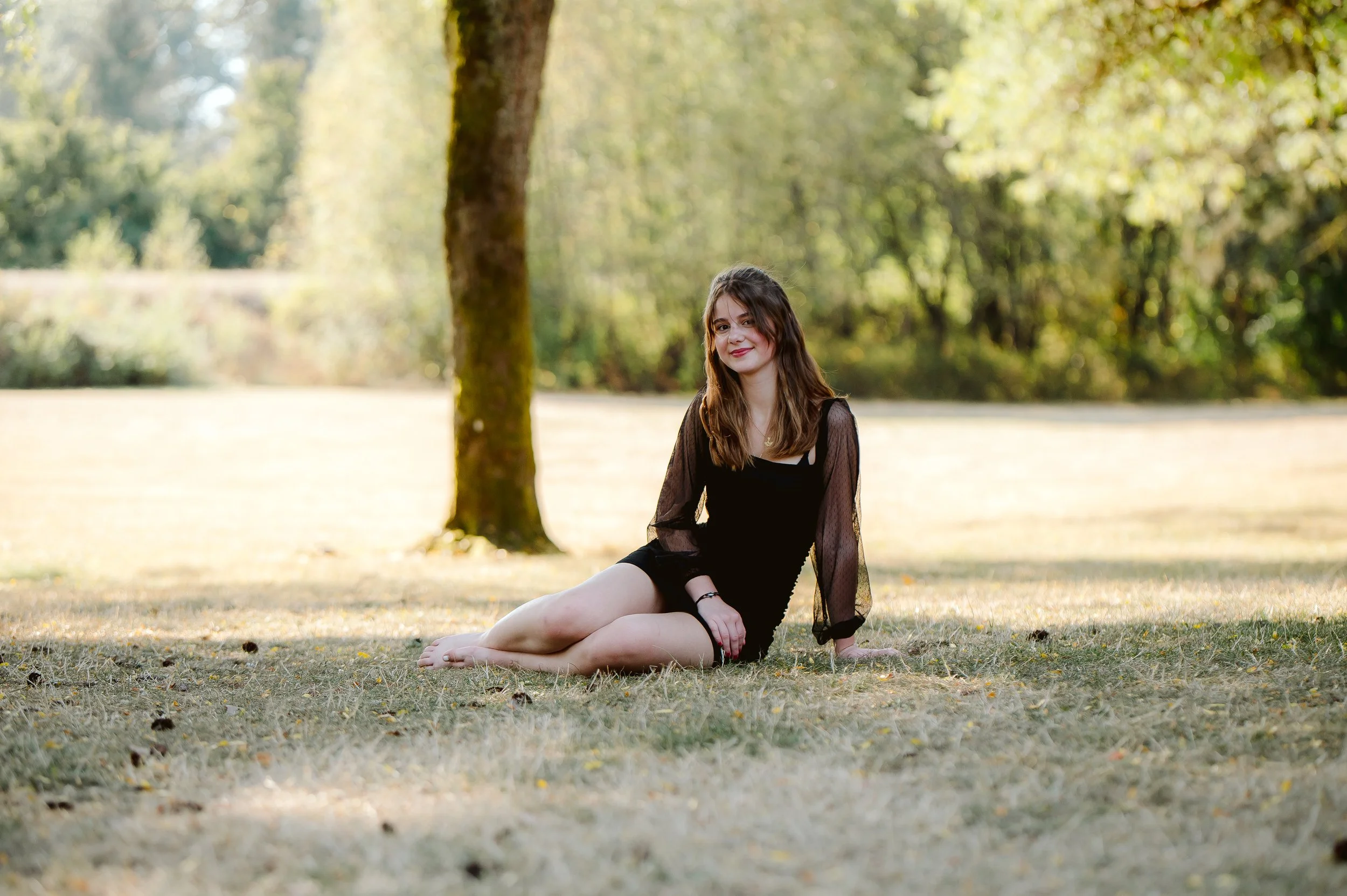 Outdoor senior photography in Vancouver Washington featuring a soft, natural setting and candid expression.