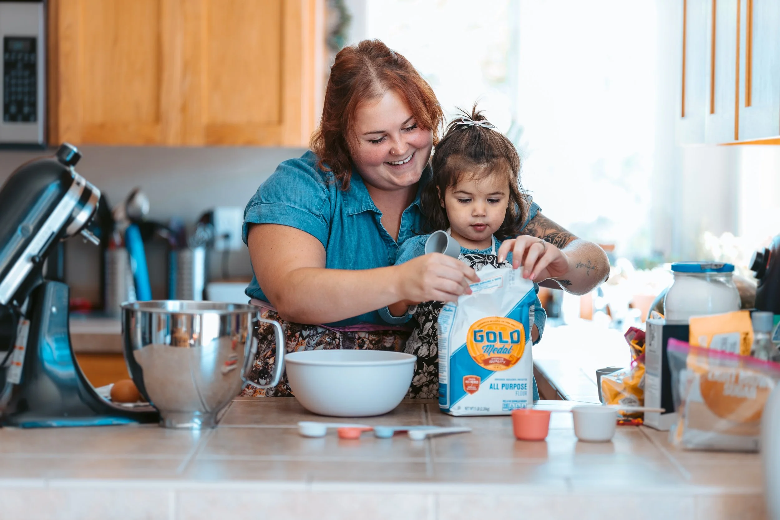 Mother baking with her young child at home, capturing everyday family memories for a meaningful Mother’s Day photo gift in Vancouver Washington.