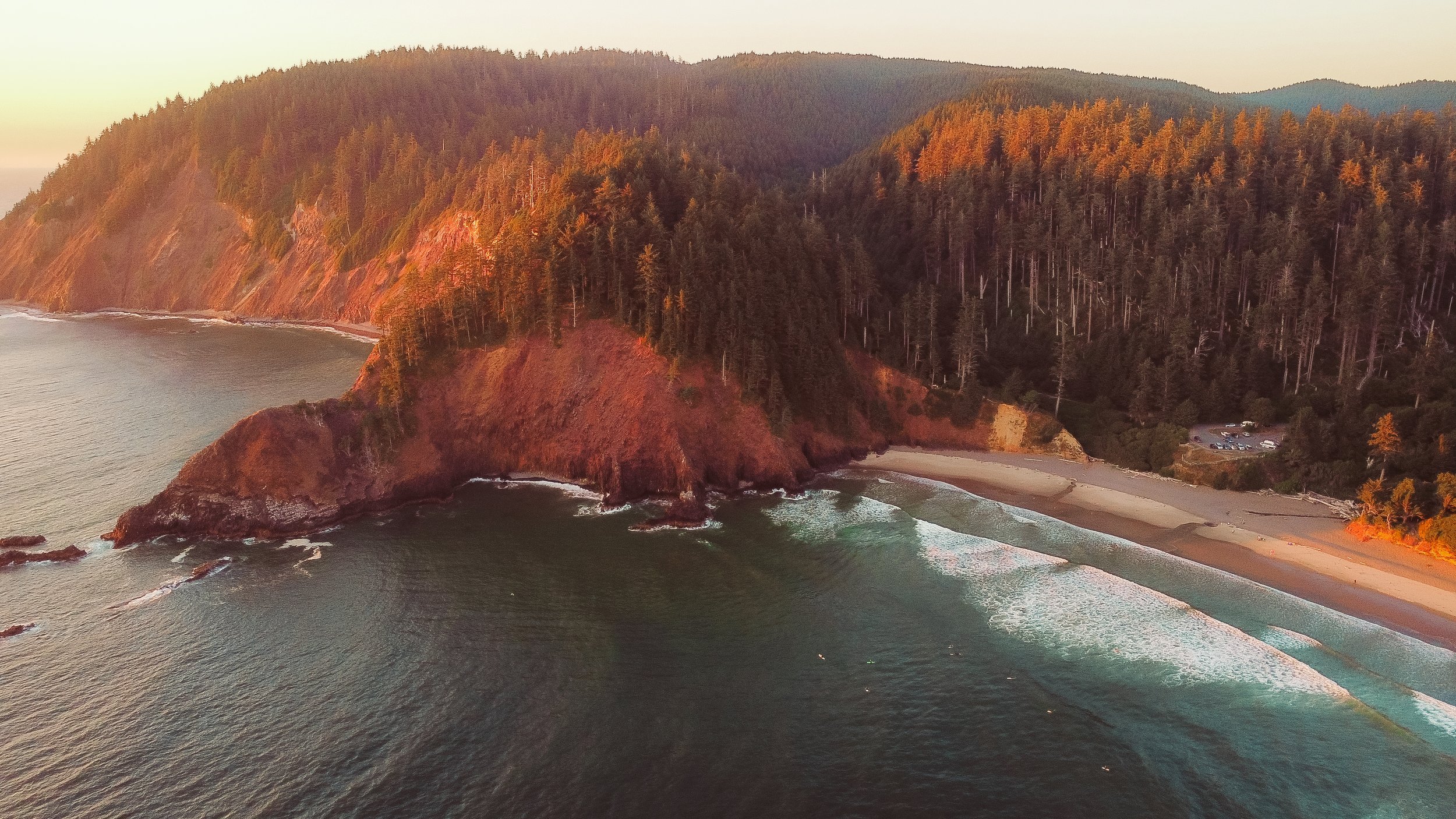 Small intimate wedding ceremony on the Oregon Coast during sunset with ocean views and close family present