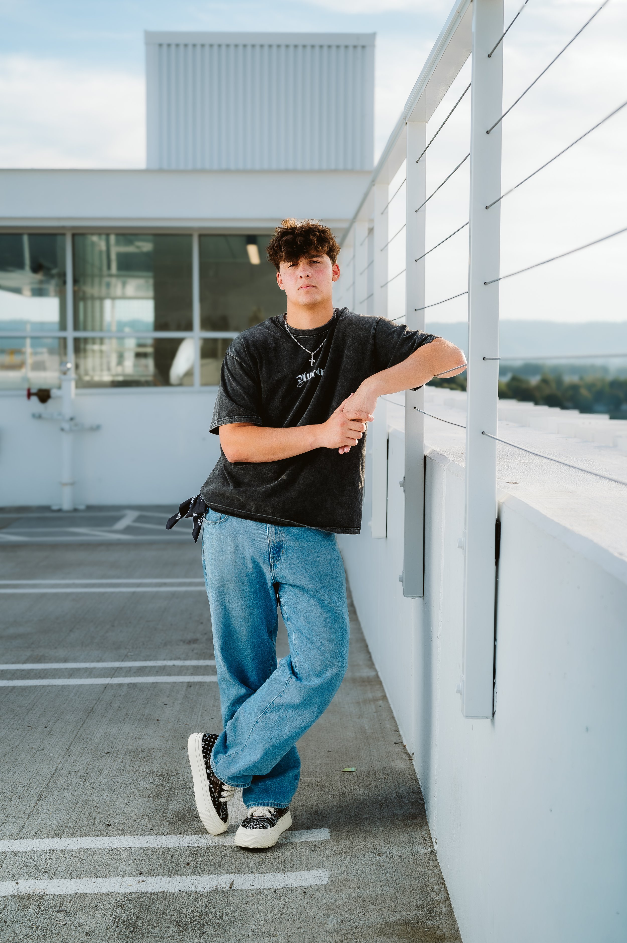 Full-length senior portrait photographed in Vancouver Washington highlighting casual styling and open space.