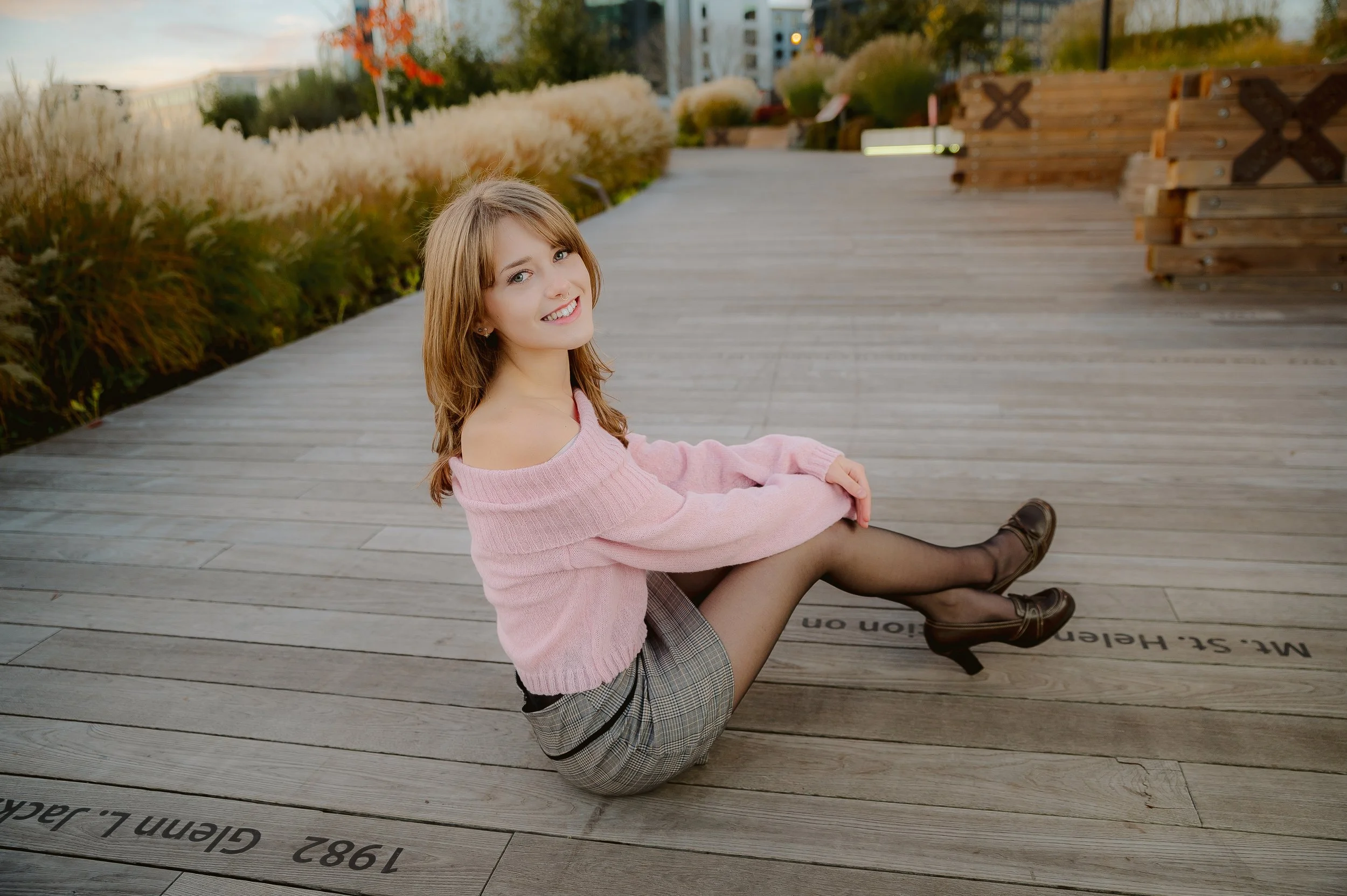 Senior girl posing in multiple outfits during a Class of 2027 senior photo session outdoors