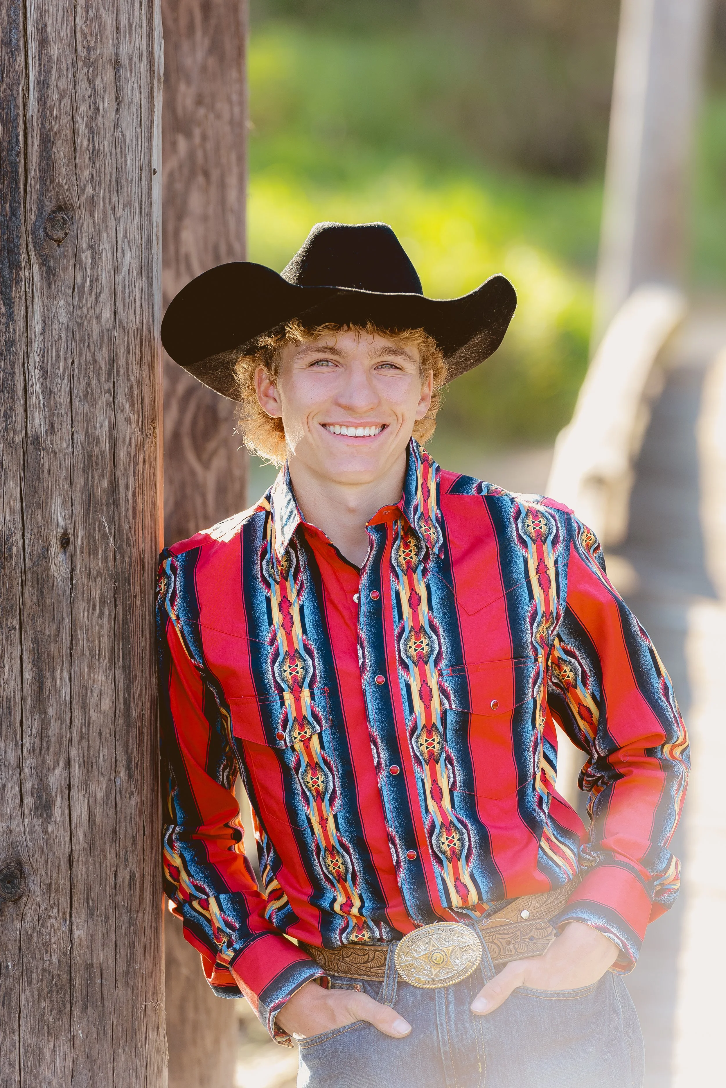 Vancouver Washington senior portrait session featuring a graduating senior in western-inspired attire during an outdoor photo shoot.