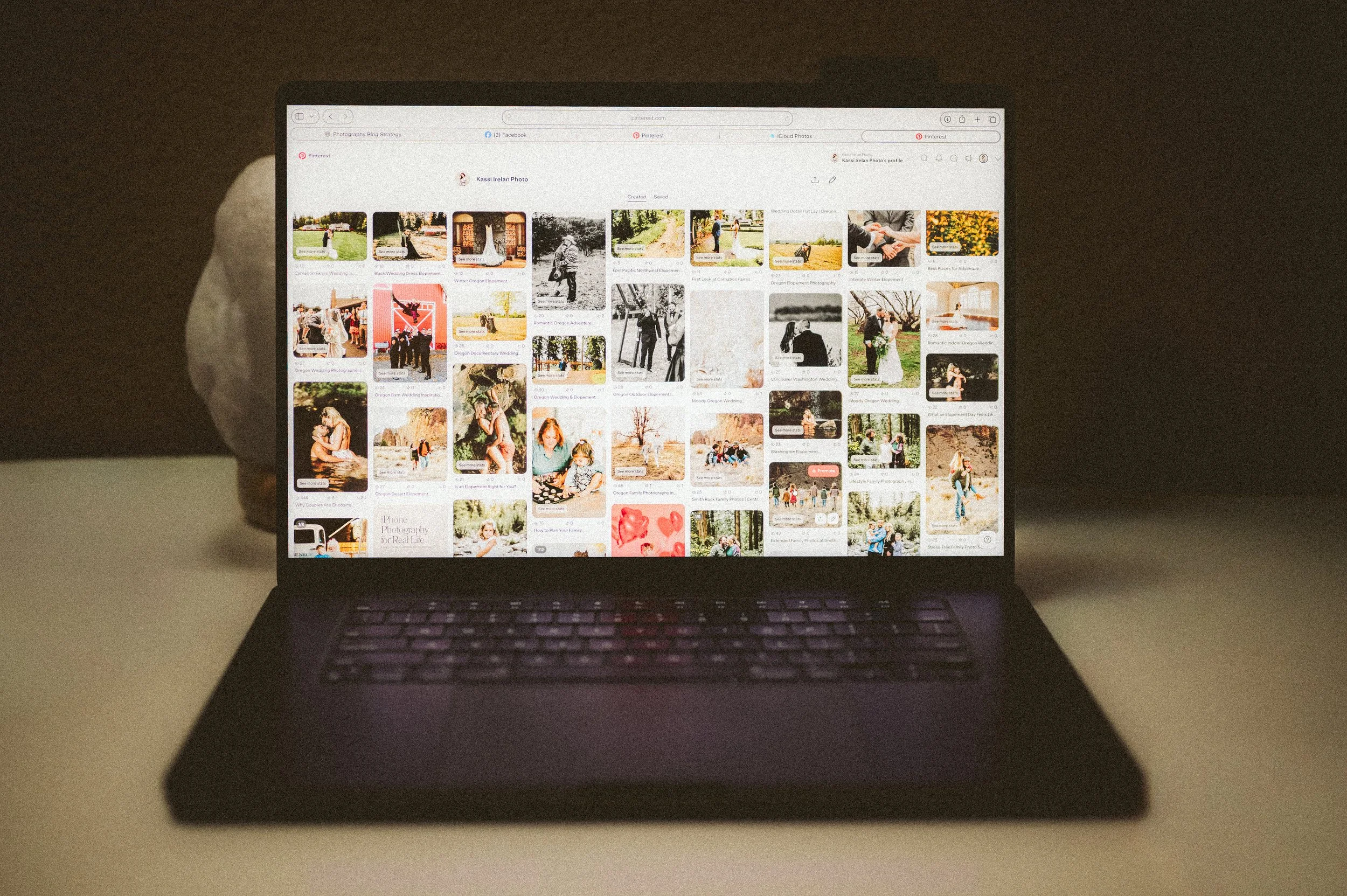 Laptop displaying Pinterest wedding inspiration boards used to plan wedding ideas and visual style.