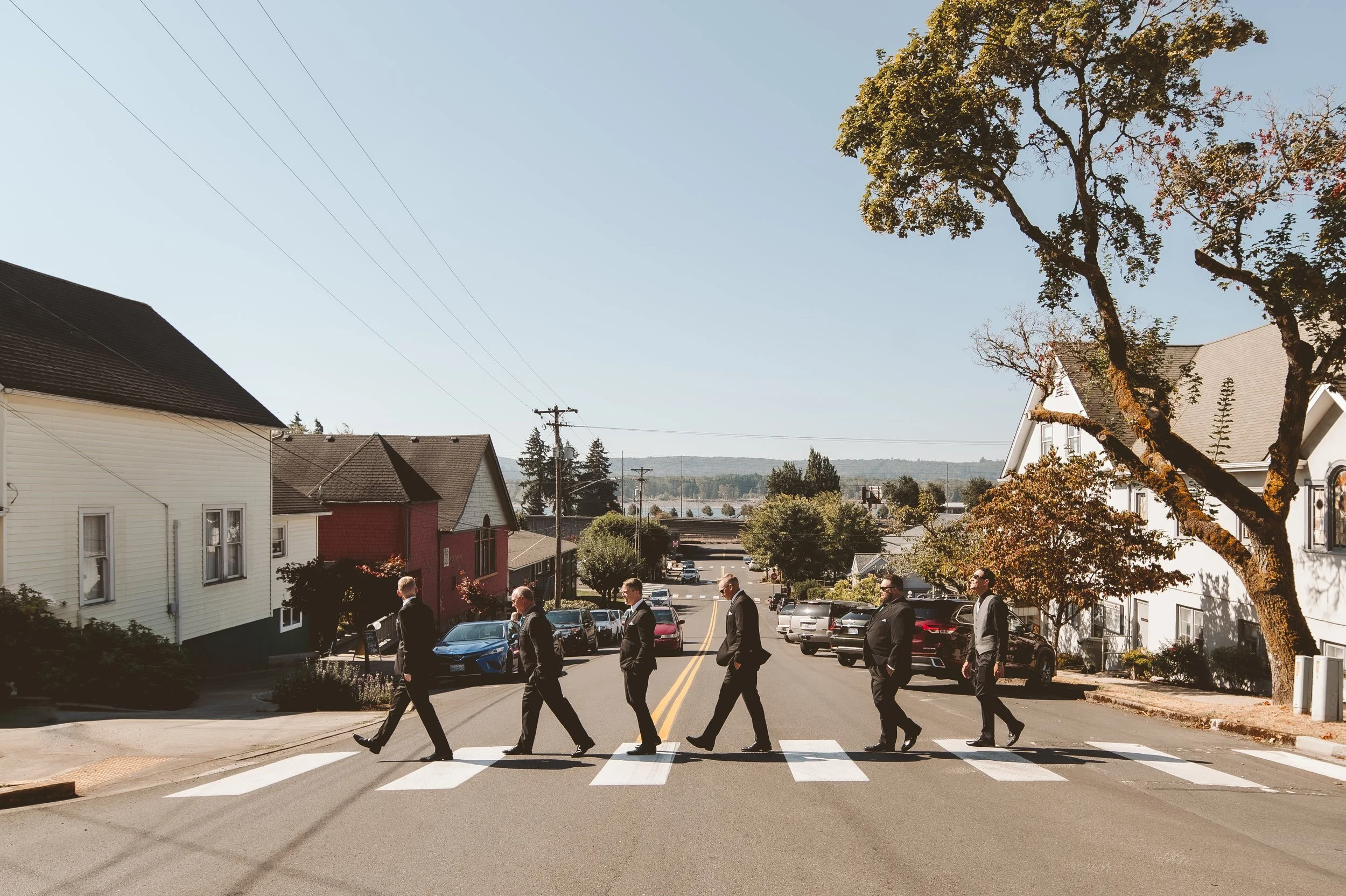 Groomsmen walking across a crosswalk in downtown Vancouver Washington during an intimate wedding day