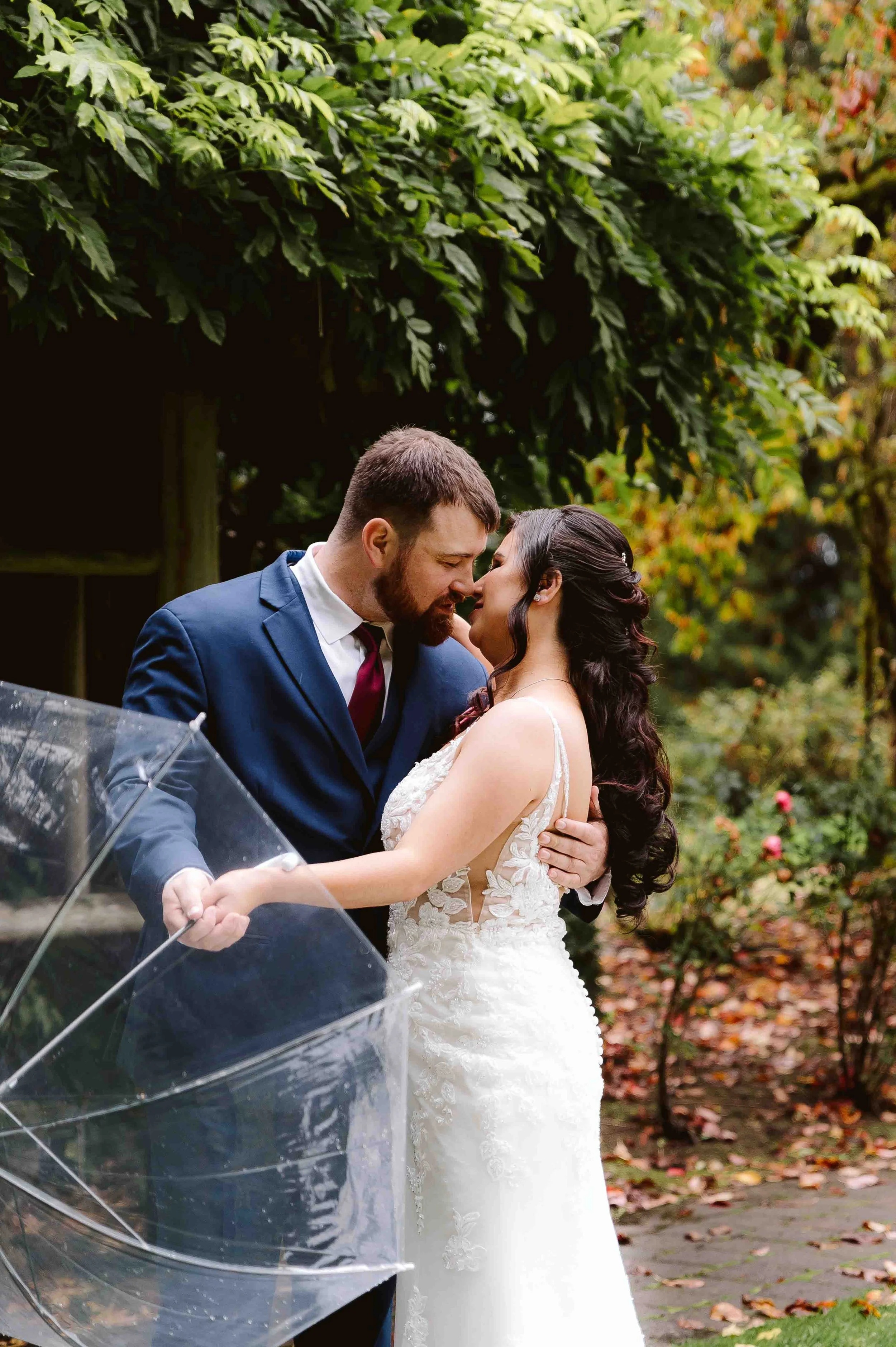 Couple embracing under umbrella during outdoor wedding in Vancouver Washington