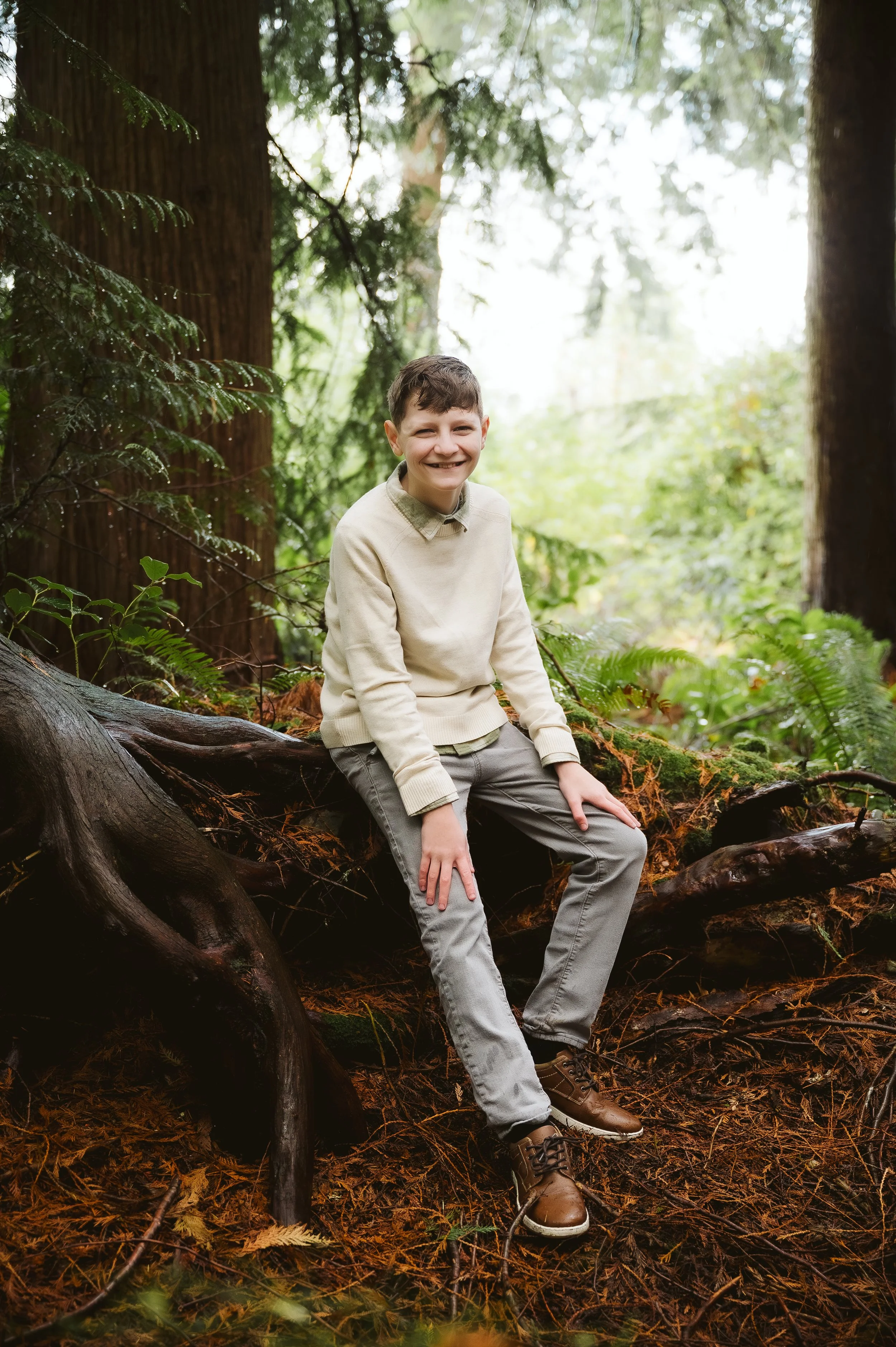 Child portrait photography in the Pacific Northwest highlighting a relaxed, natural pose in a wooded outdoor setting.