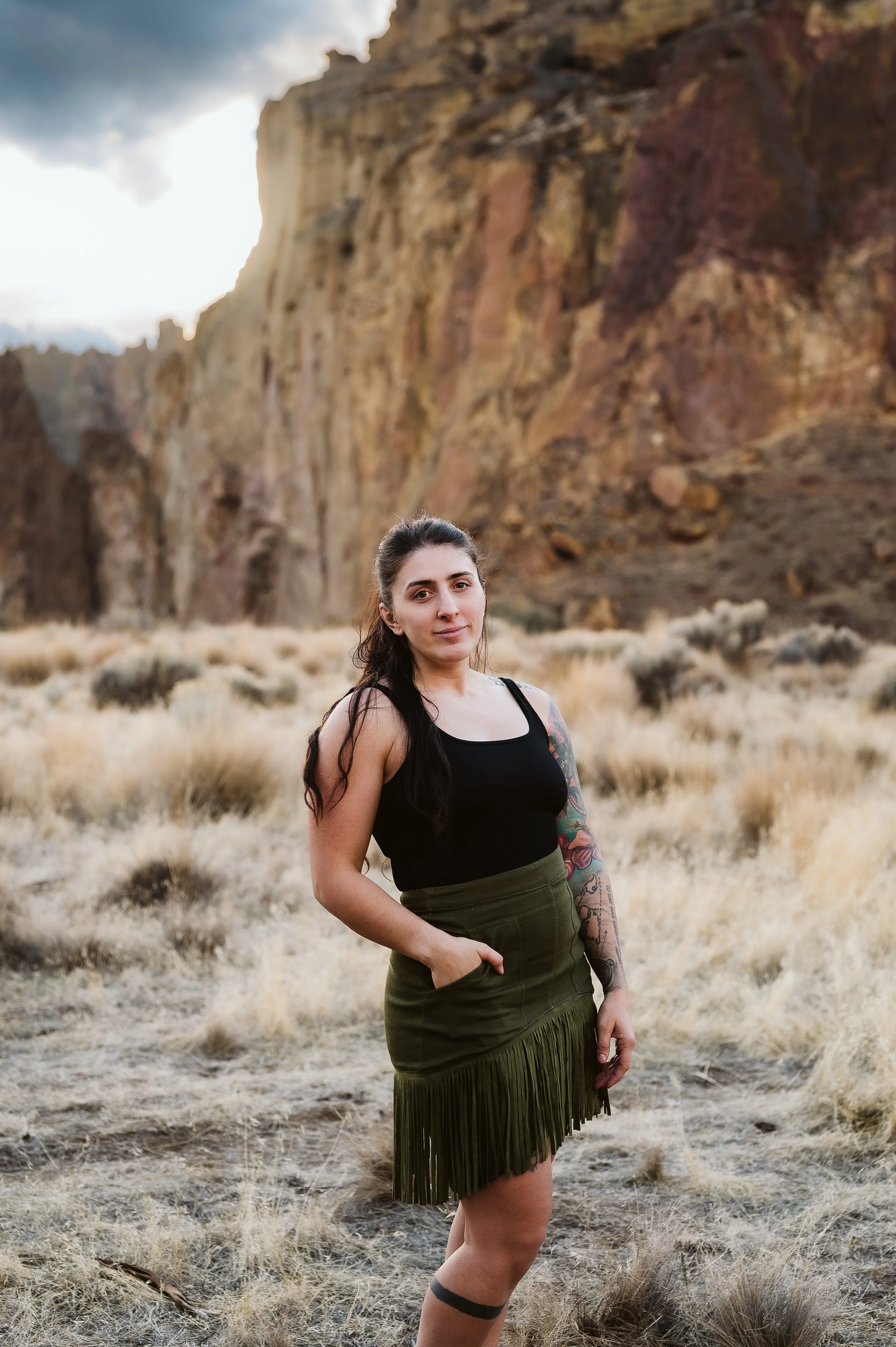 Woman standing in a rocky desert landscape during an outdoor portrait session