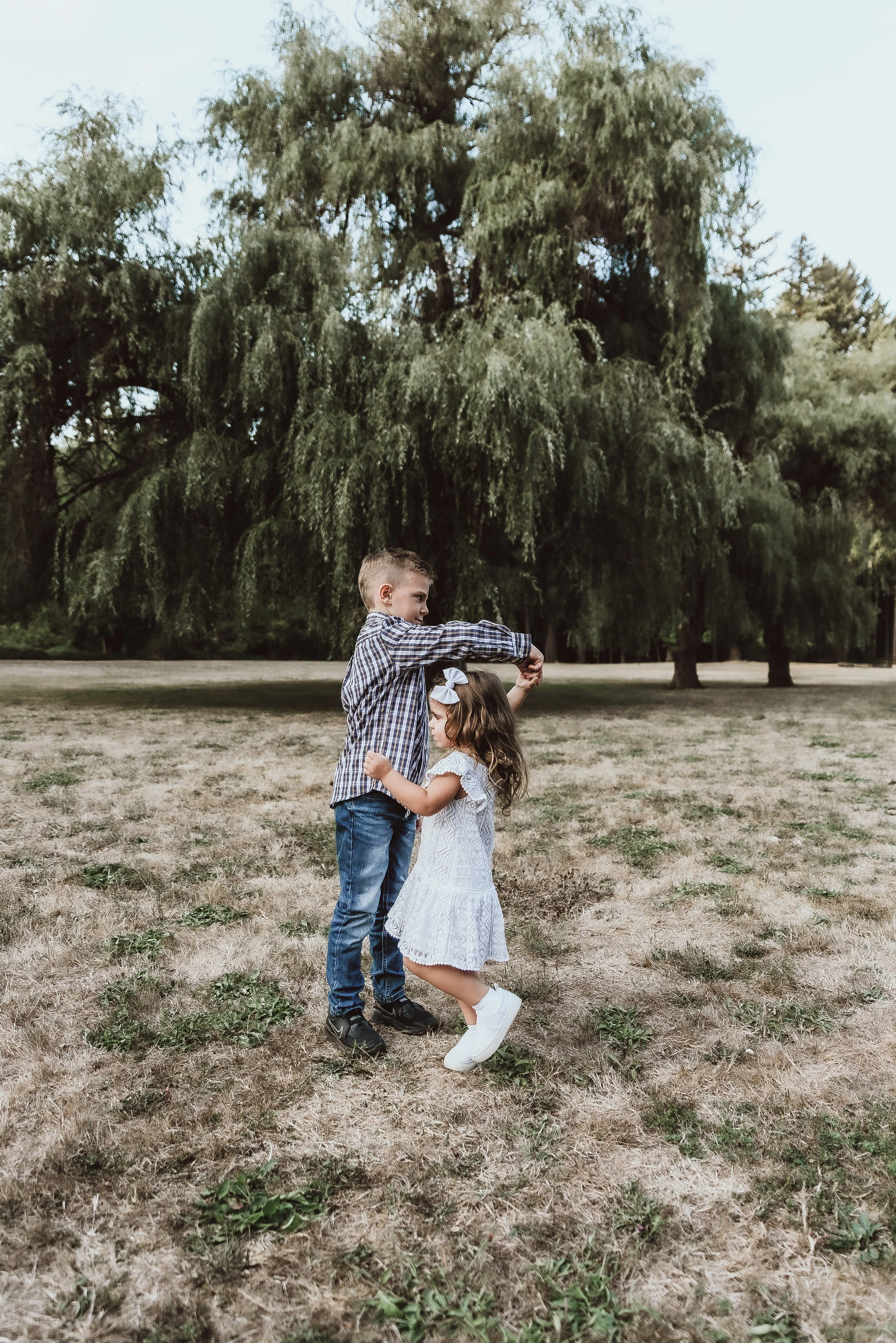 Children playing together during an outdoor family photo session in Vancouver, WA