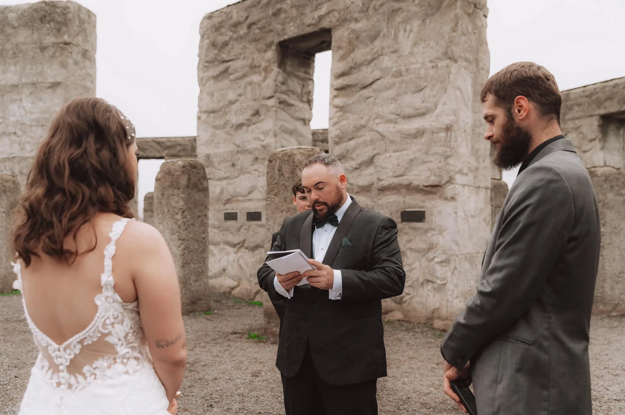 Couple exchanging vows during an intimate micro wedding ceremony at the Stonehenge Memorial overlooking the Columbia River Gorge.