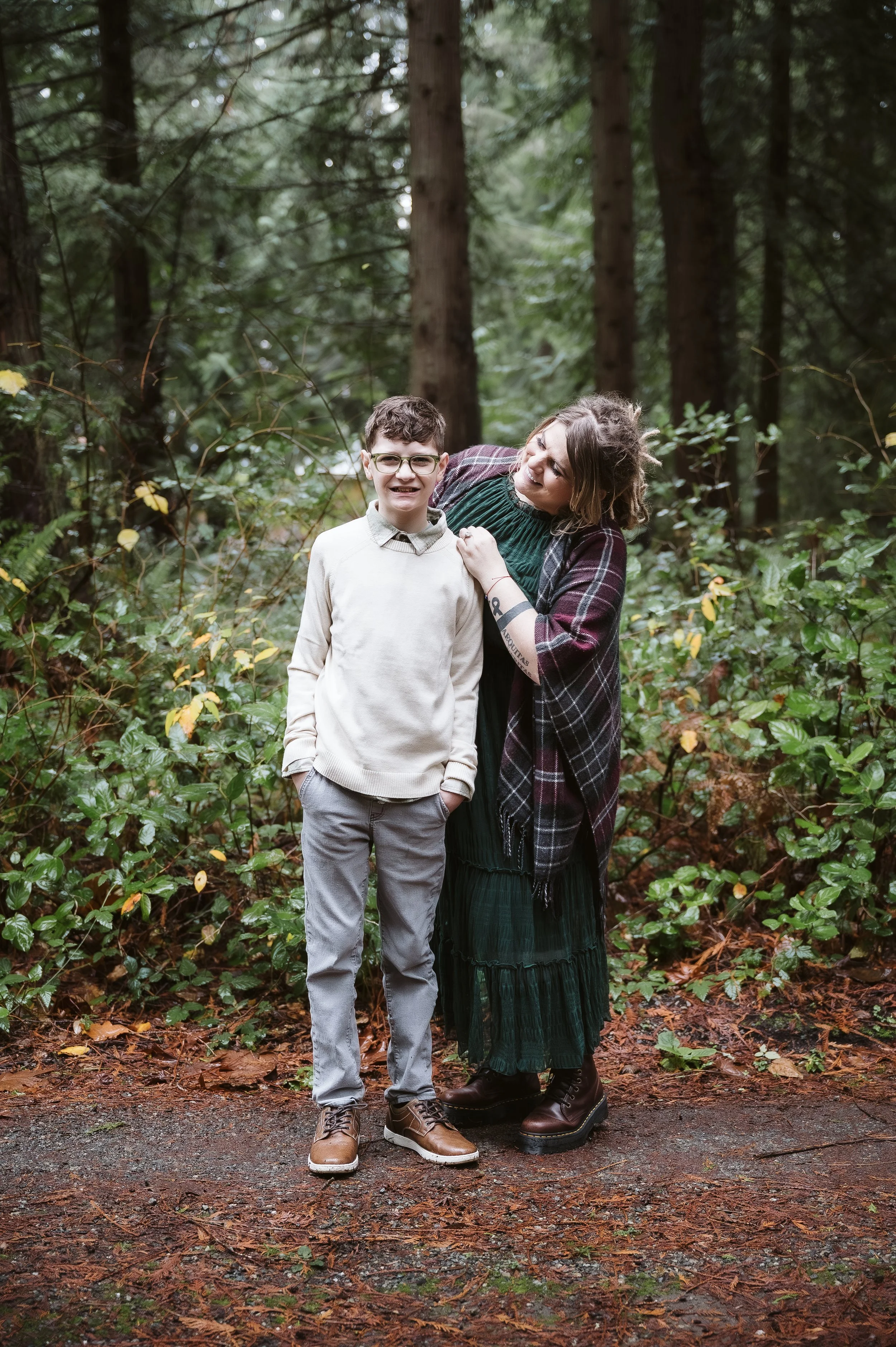 Parent and child photography in Oregon capturing affection and laughter during a forest family session.